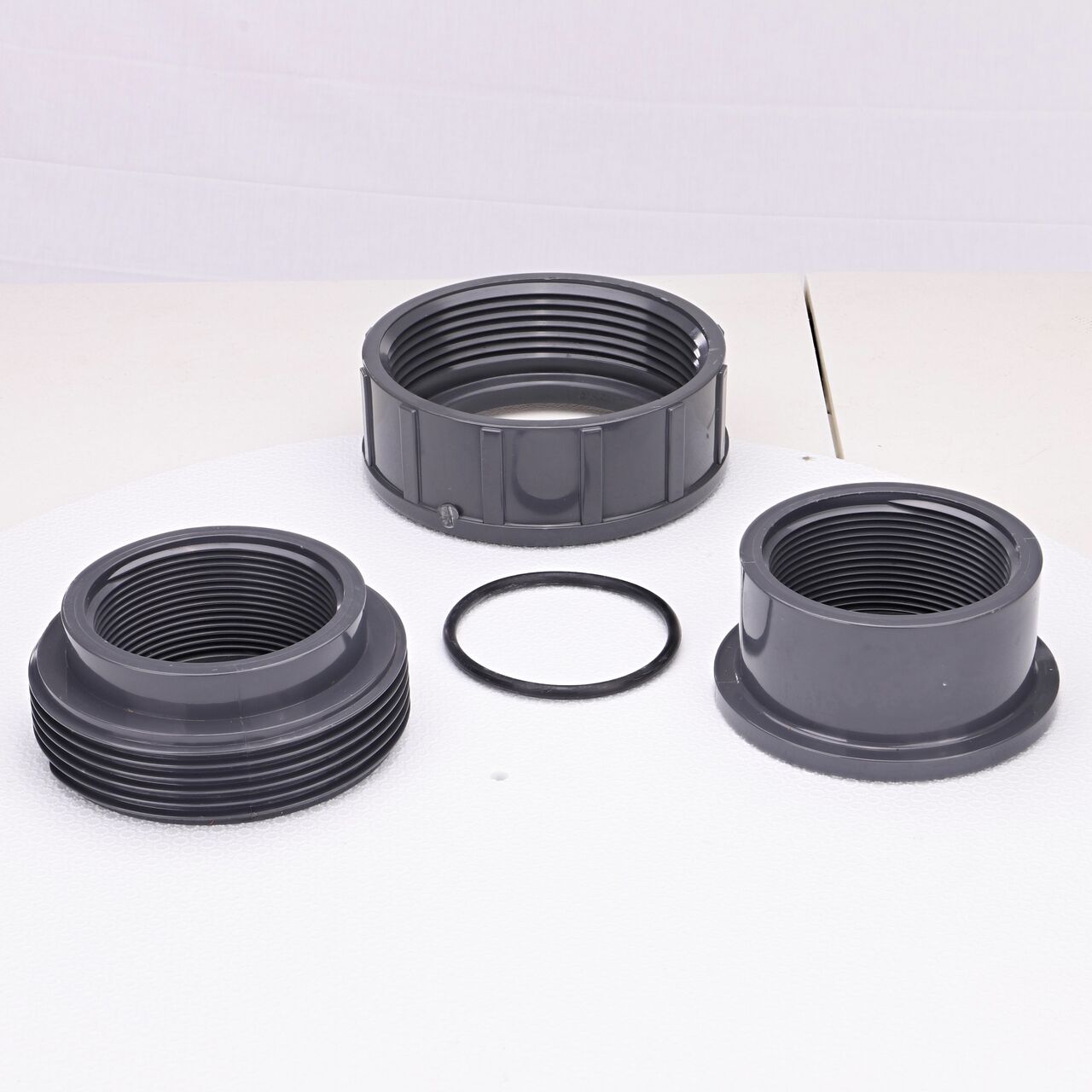 The NDS 3 in. FPT PVC Union shown here unassembled, includes the EPDM O-ring that is placed in the center of the union to create a leak-resistant seal (NDS U-3000-T)