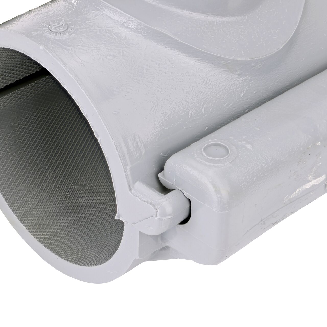 Closeup of the hinge closed on the NDS Clamp-It™ Rigid PVC Saddle with 1 in. slip connection on top (NDS 432010) for 2 in. PVC pipe