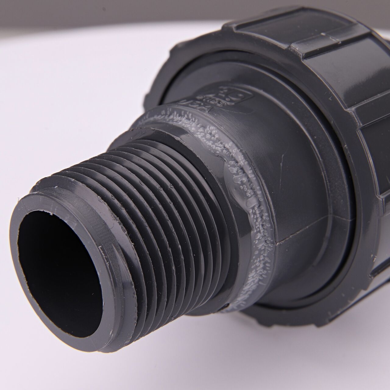 Closeup view of one threaded end on the PVC Union, 1 in. Sch. 80 FPT X MPT (NDS U-1000-TM)