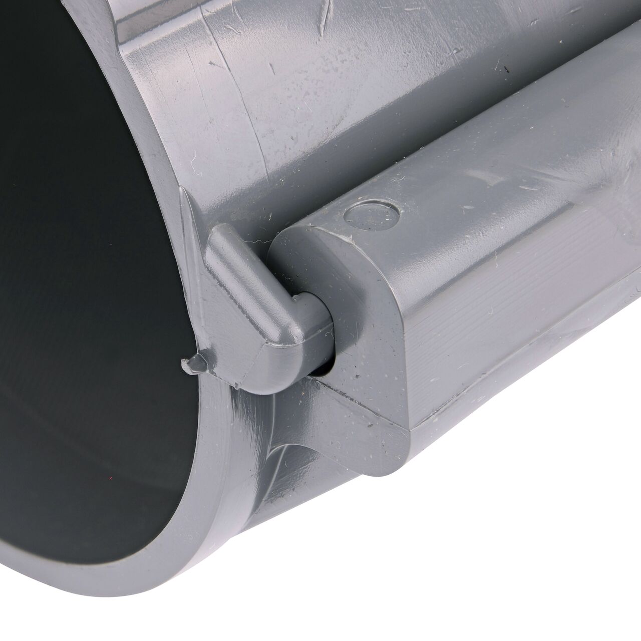 Closeup of the hinge closed on the NDS Clamp-It™ Rigid PVC Saddle with 3/4 in. FPT connection on top (NDS 444007) for 4 in. PVC pipe