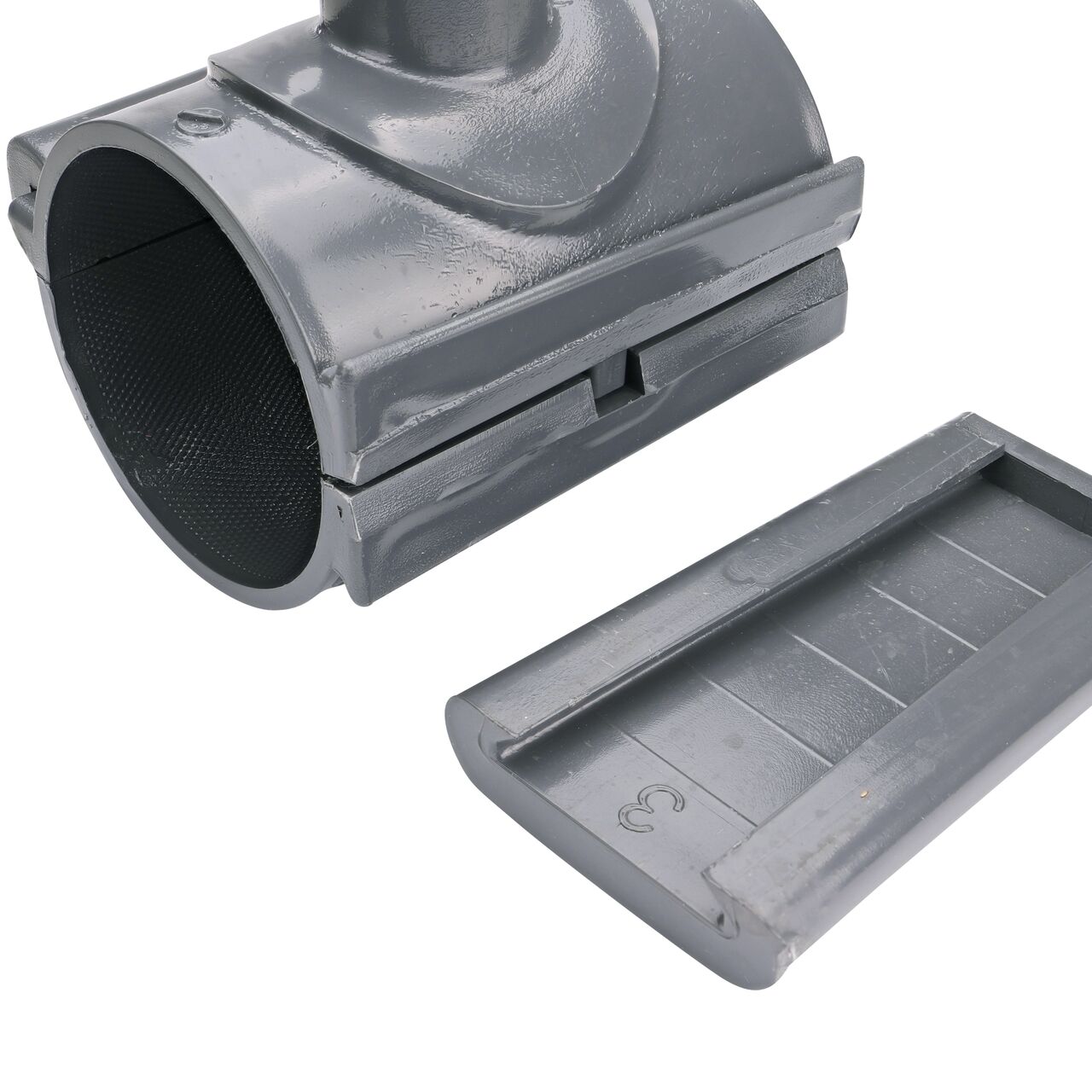 Closeup of the wedge latch uninstalled on the NDS Clamp-It™ Rigid PVC Saddle with 1 in. slip connection on top (NDS 453010) for 3 in. PVC pipe