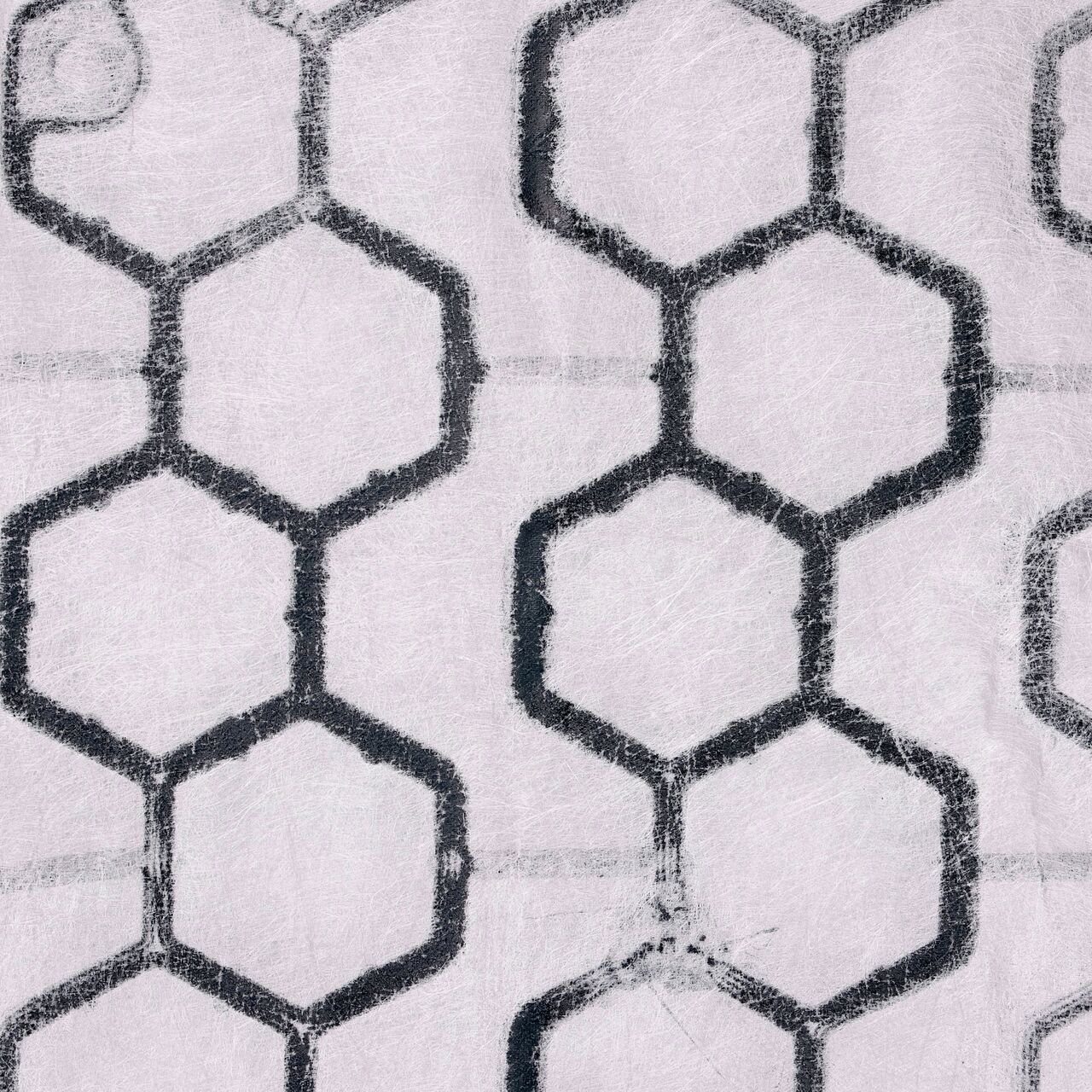 Top Down View of the back side of the Black NDS EZ Roll® Gravel Pavers, with thermally welded, puncture-resistant geotextile fabric
