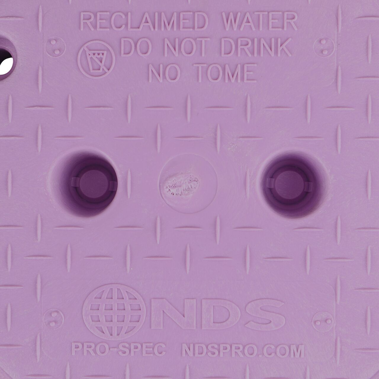 Closeup view of the Reclaimed Water markings on the Purple Reclaimed Water cover for the NDS 10 in. Round Pro-Spec® Series Valve Box (NDS 311BCR)