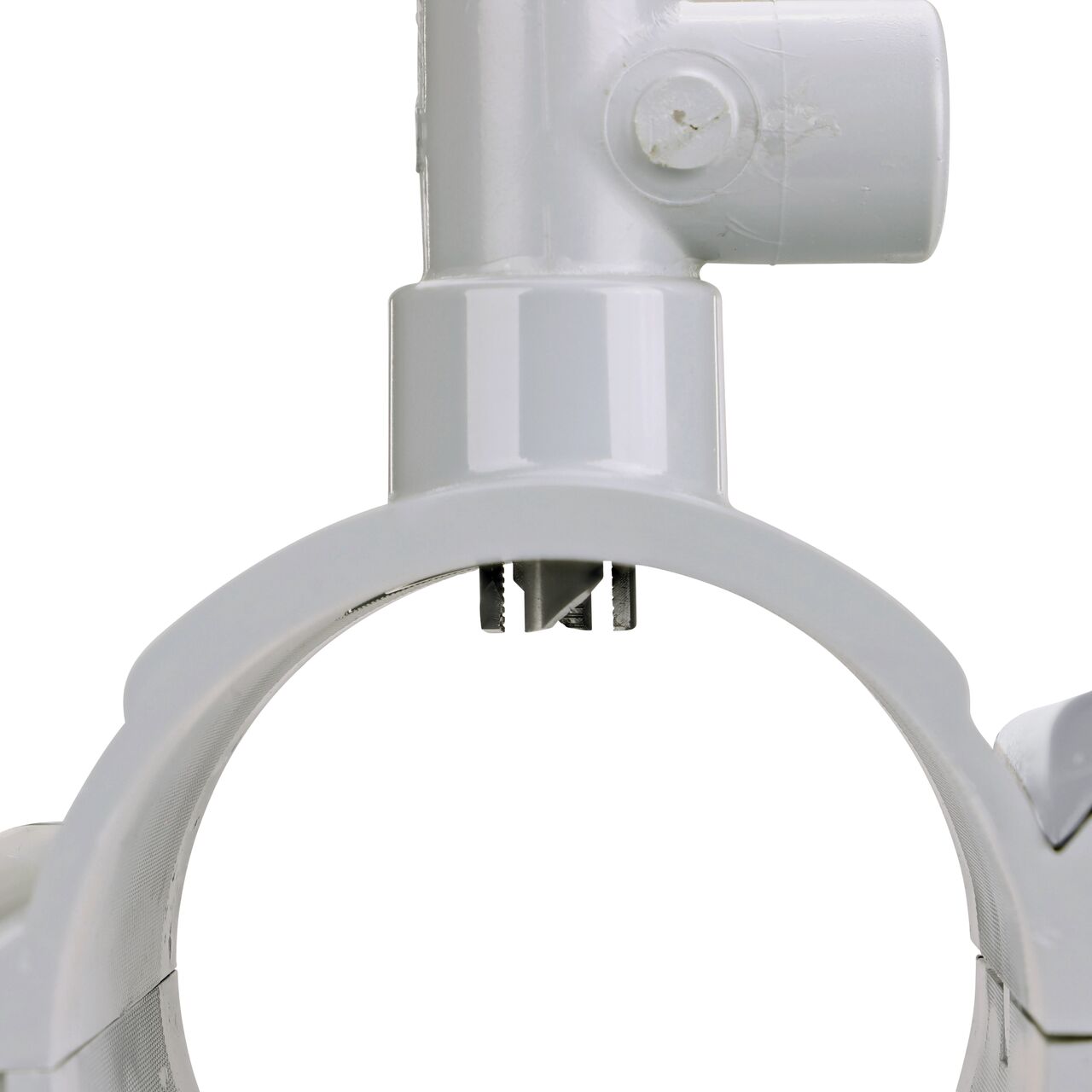 Closeup view of the built-in saw tooth cutter in position as if cutting pipe on the 4 in. NDS Flo-Tap™ Rigid PVC saddle (NDS 3140) which cuts easily through PVC pipe wall and captures debris before it can enter the water supply
