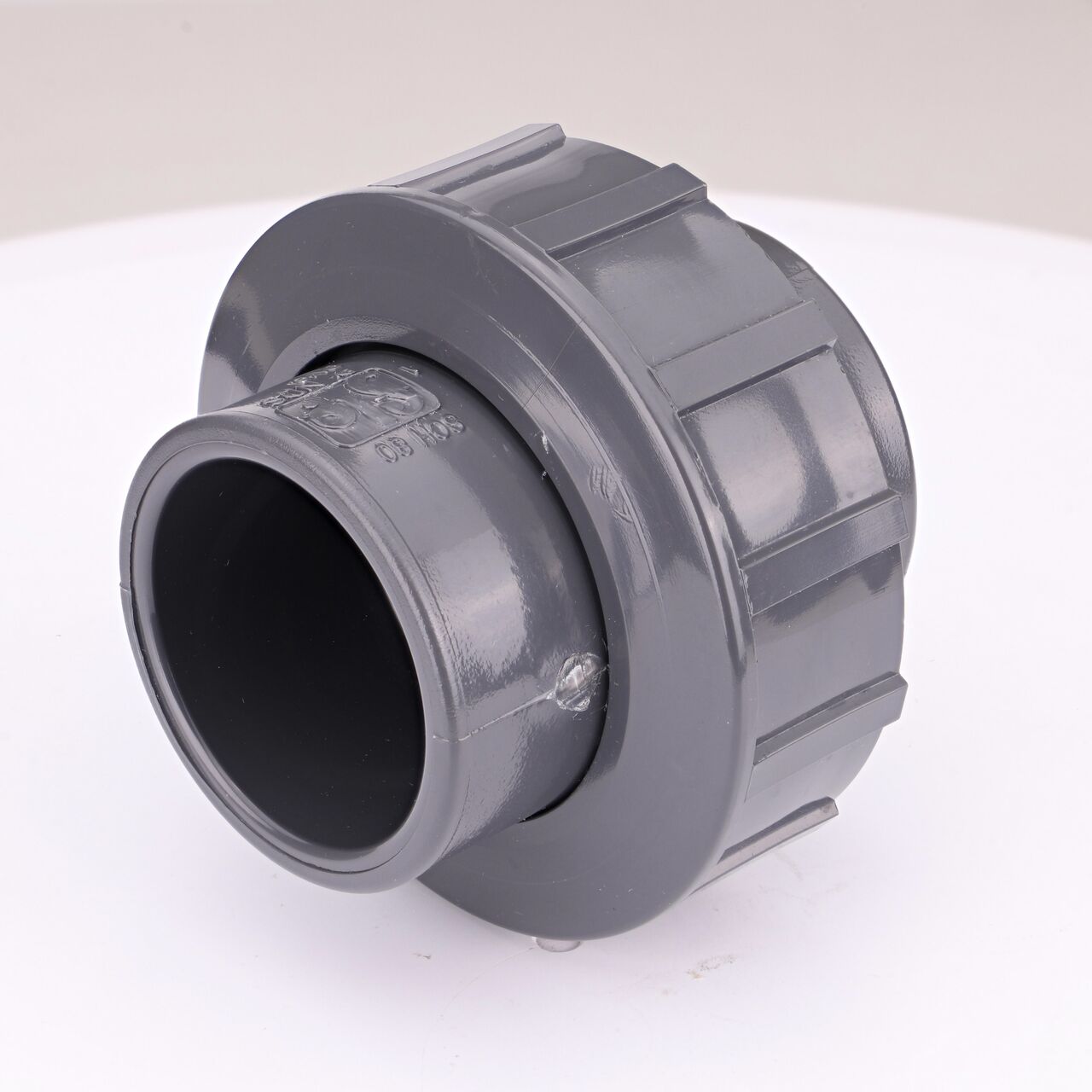One end of the PVC Union, 1-1/2 in. Sch. 80 S X FPT which connects two 1-1/2 in. Sch. 80 pipes together to allow water to flow through while preventing leaks (NDS U-1000-ST)