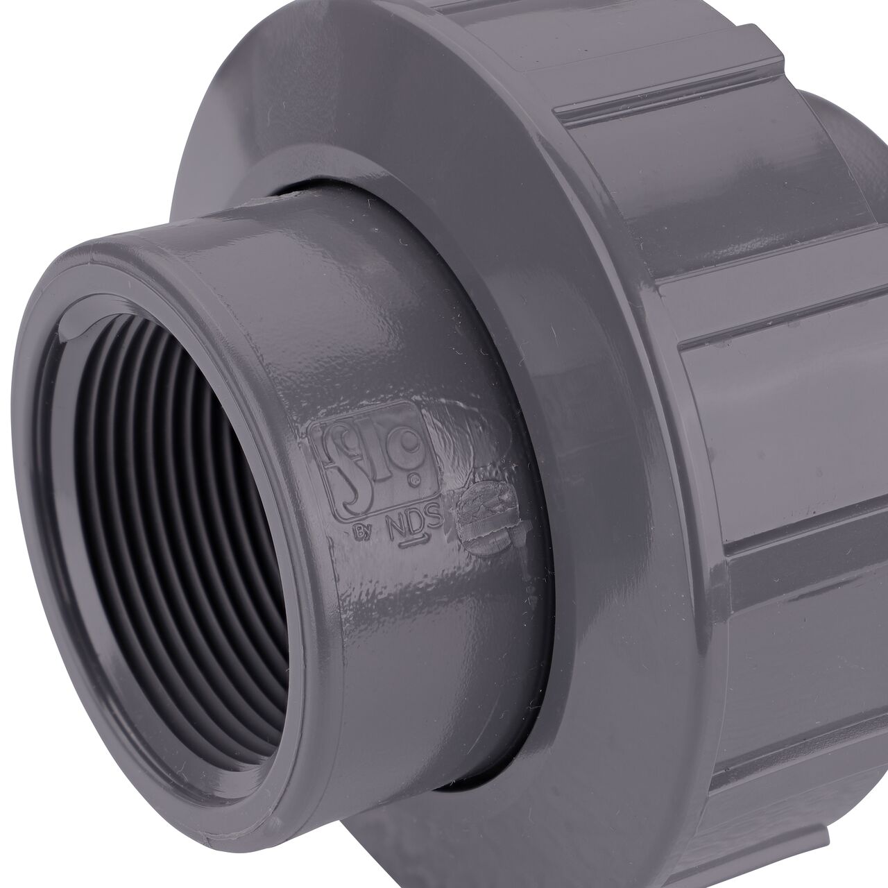 Close up view of the NDS 1-1/2 in. PVC FPT Union showing NDS brand a leader in flow management solutions and the preferred choice of professionals since 1972 mark (NDS U-1500-T)
