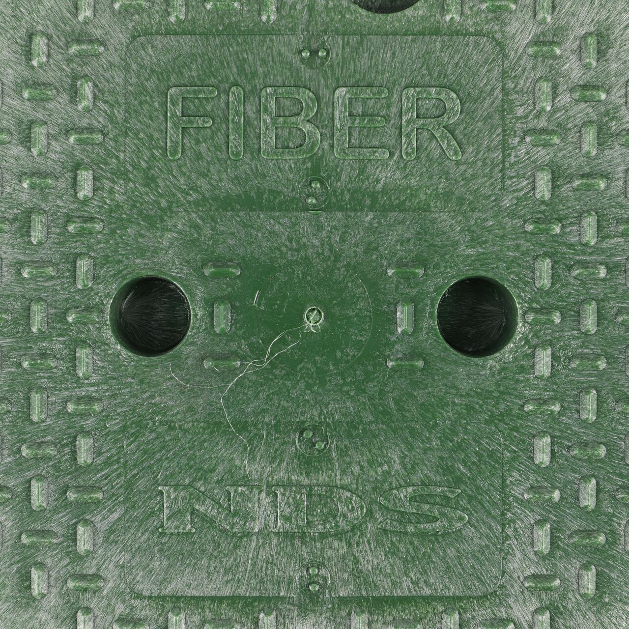 Closeup view of the fiber markings on the green cover for the NDS 10 in. Round Standard Series Valve Box (NDS 111CF)