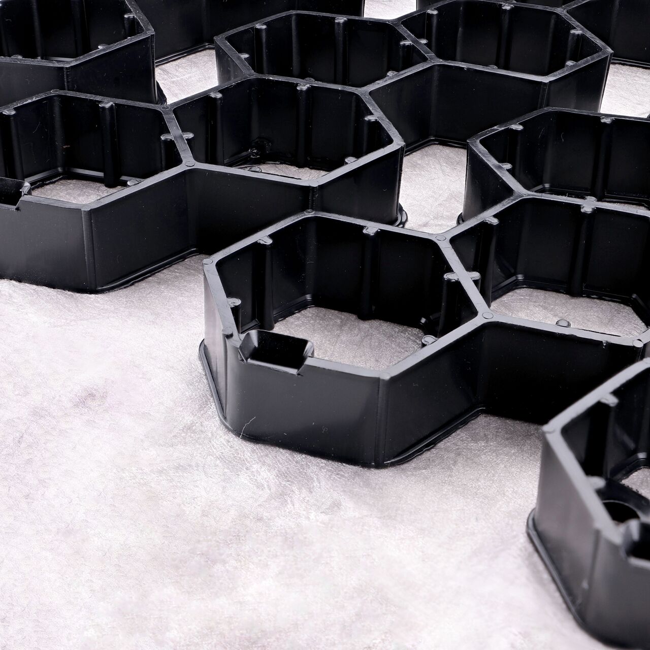 Closeup View of the side by side top-down locking tab grooves on the Black NDS EZ Roll® Gravel Pavers (NDS GP4X150)