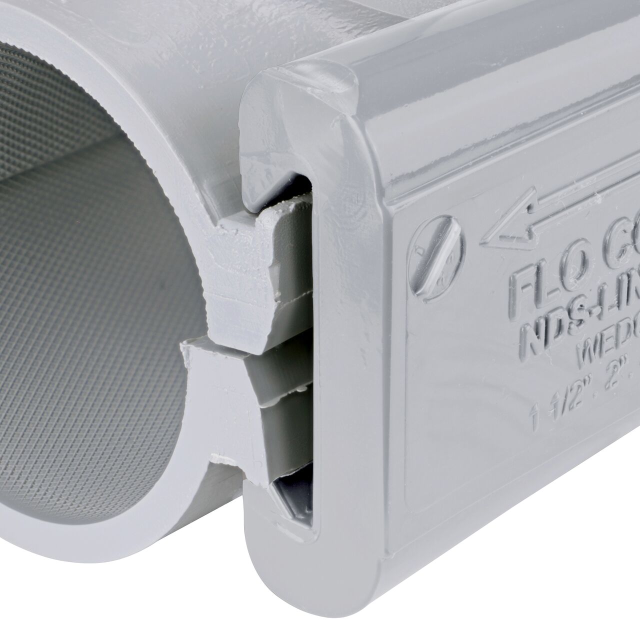 Closeup of the wedge installed securely on the NDS Clamp-It™ Rigid PVC Saddle with 3/4 in. FPT connection on top (NDS 422007) for 2 in. PVC pipe