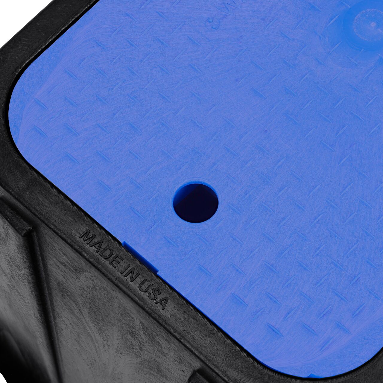 Closeup view of the pipe hole on the Black NDS 14 in. X 19 in. Rectangular Standard Series Meter Box (NDS D1200-DISBLU) for water and irrigation pipe connections