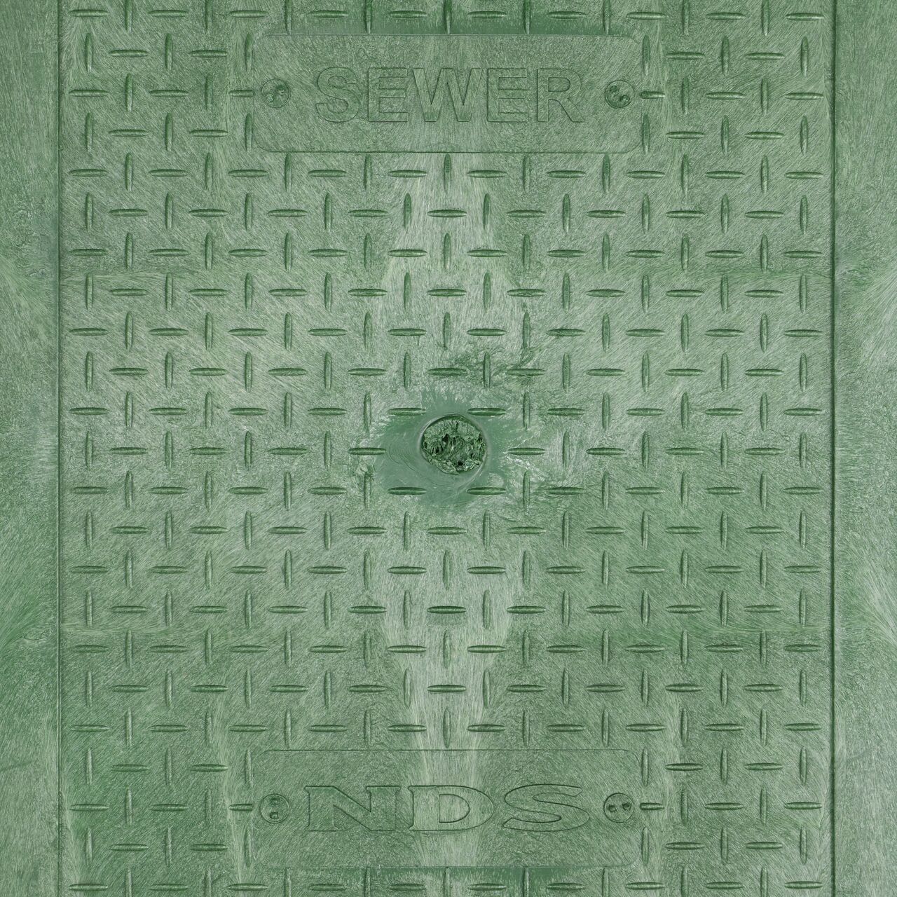 Closeup view of the Sewer markings on the Green Sewer cover for the NDS 14 in. X 19 in. Rectangular Standard Series Valve Box (NDS 114BCS)