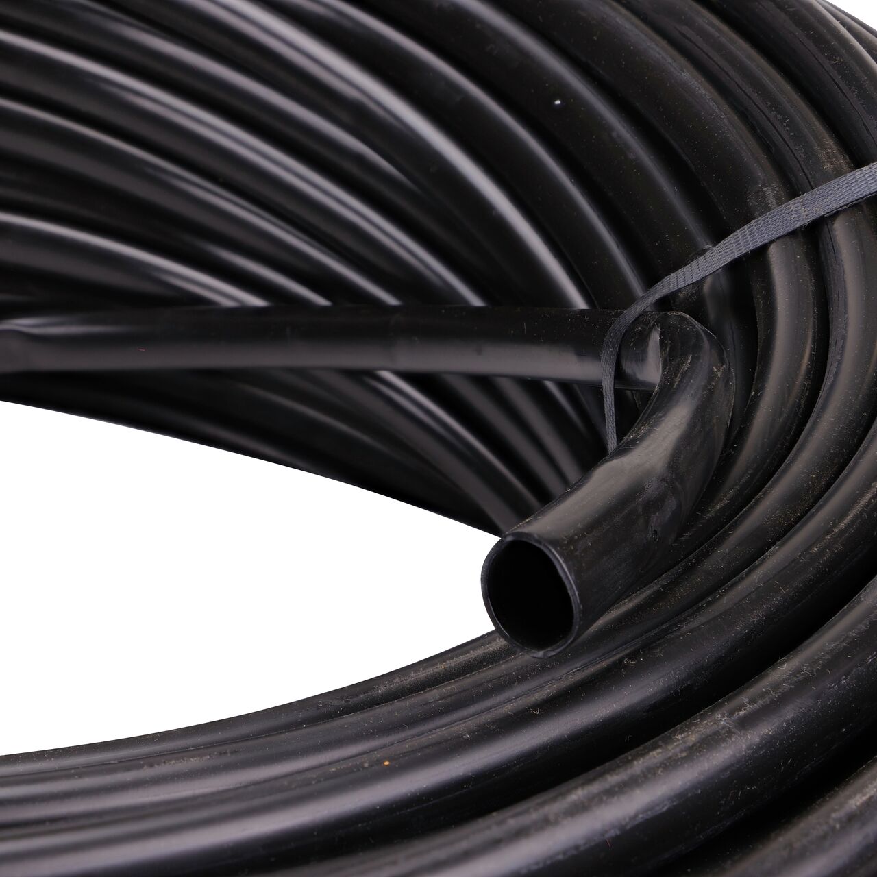 Closeup of the diameter of the NDS 500 ft. Black Tubing with 1.0 GPH Pressure Compensating Emitters with 12 in. Spacing (NDS SFPC-BL-6418-05)