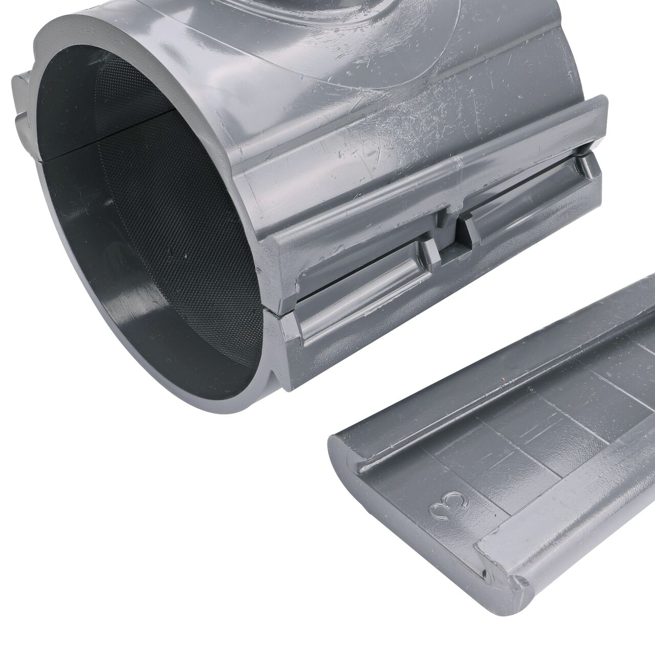 Closeup of the wedge latch uninstalled on the NDS Clamp-It™ Rigid PVC Saddle with 1-1/2 in. slip connection on top (NDS 454015) for 4 in. PVC pipe