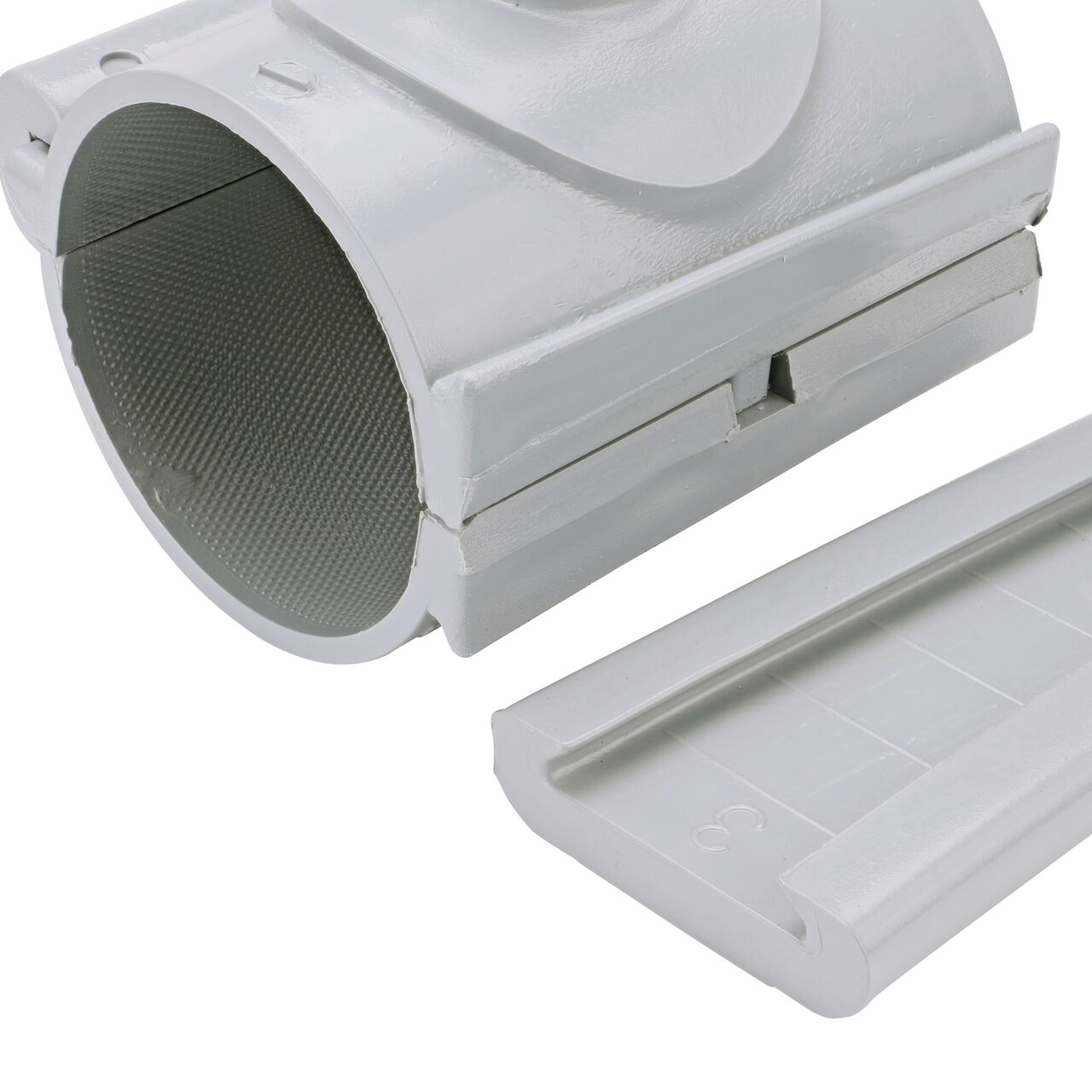 Closeup of the wedge latch uninstalled on the NDS Clamp-It™ Rigid PVC Saddle with 3/4 in. slip connection on top (NDS 453007) for 3 in. PVC pipe