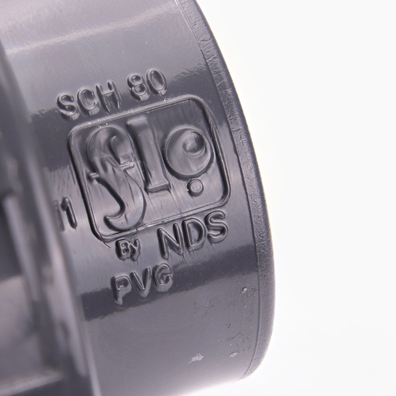 Closeup view of the NDS PVC Union shows each end is labeled that it connects to 1-1/2 in. Schedule 80 pipe for residential, commercial, and industrial applications (NDS U-1500-S)