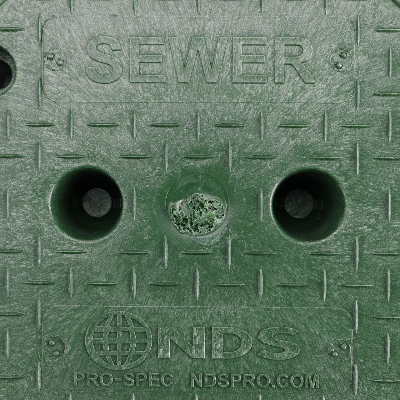 Closeup view of the Sewer markings on the Green Sewer cover (NDS 312BCS) for the NDS 10 in. Round Pro-Spec® Series Valve Box