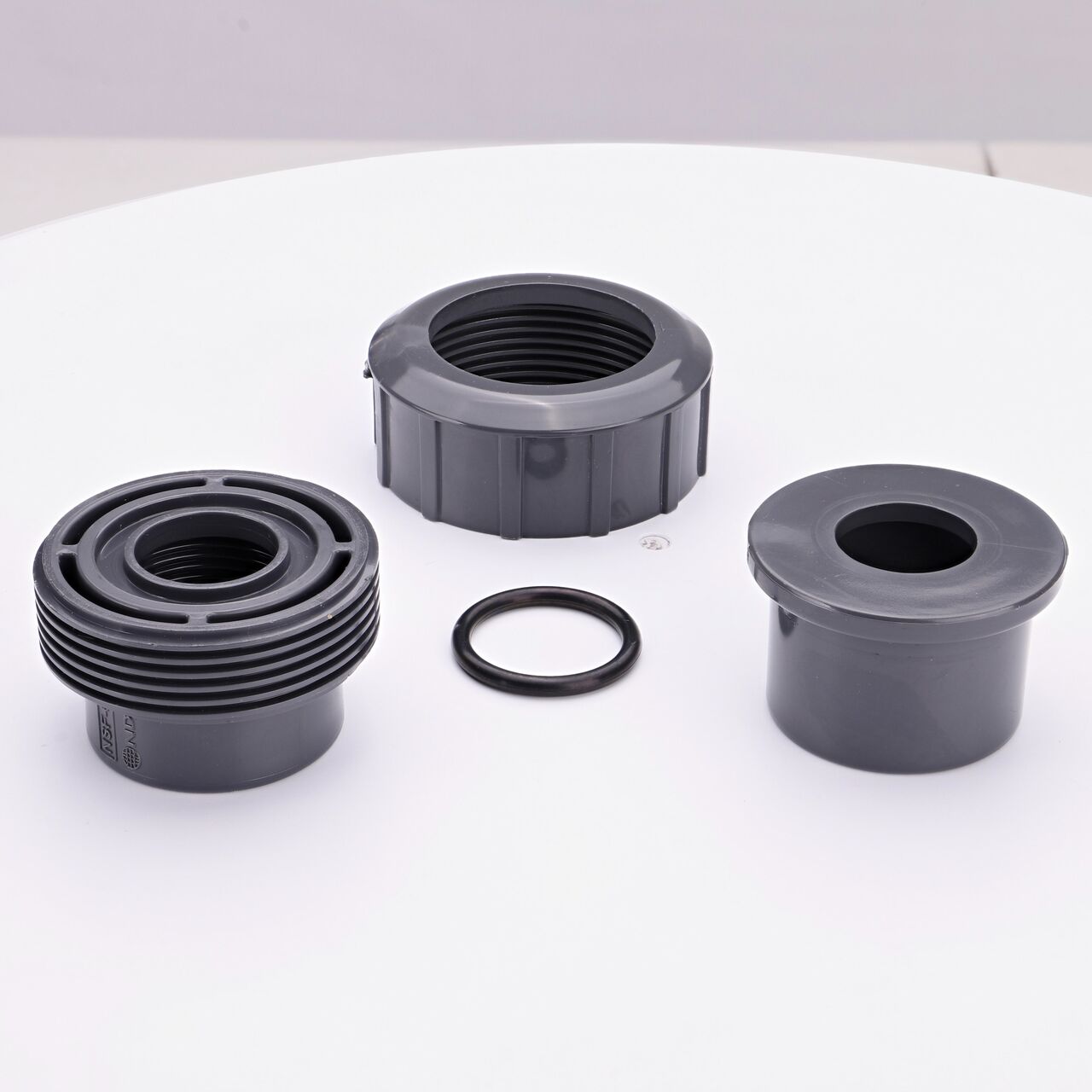 NDS PVC Union Ball Valve unassembled showing all the pieces including the female threaded ends facing upwards that connect two 1 in. Sch. 80 pipes