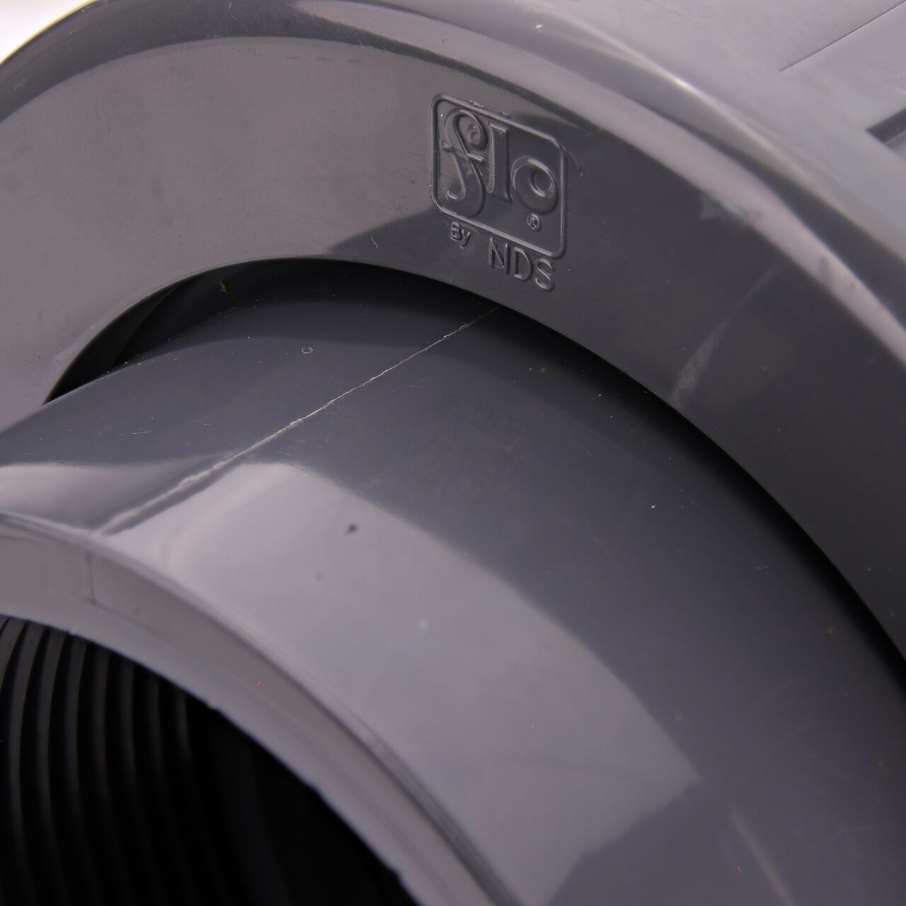 Closeup view of the NDS PVC Union shows each end is labeled that it connects to 3 in. Schedule 80 pipe for residential, commercial, and industrial applications (NDS U-3000-T)