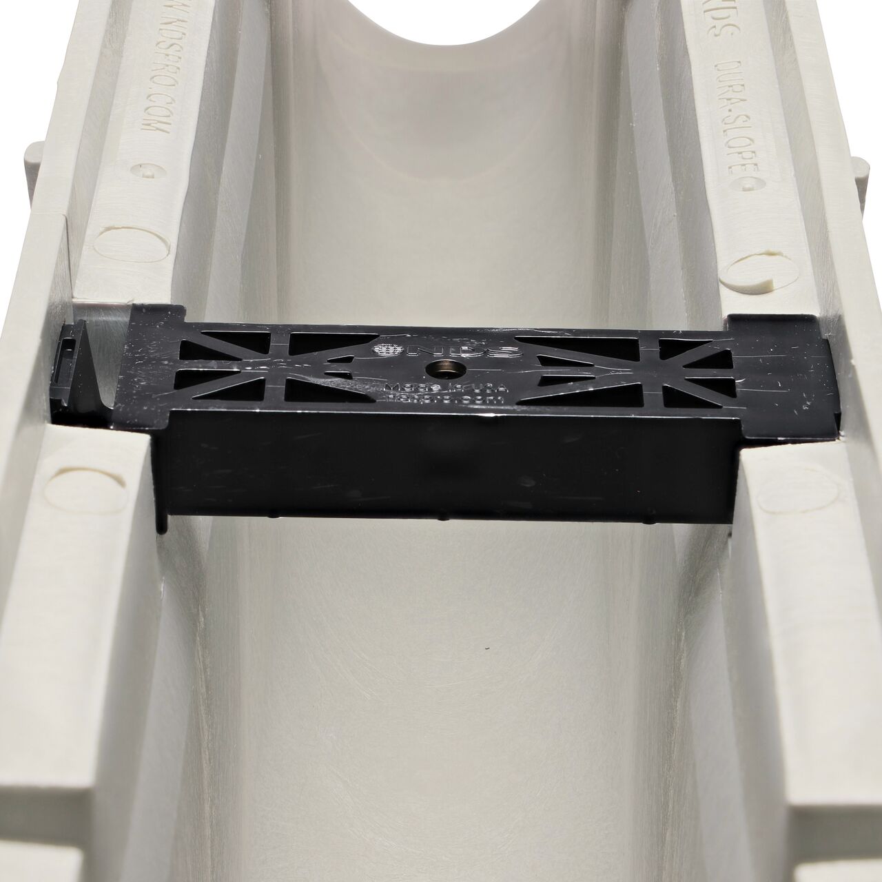 Closeup view of the grate locking system on the NDS Dura Slope Channel Drain, which locks grate to the integral frame (NDS DS-109N, NDS DS-110, NDS DS-111, NDS DS-112)