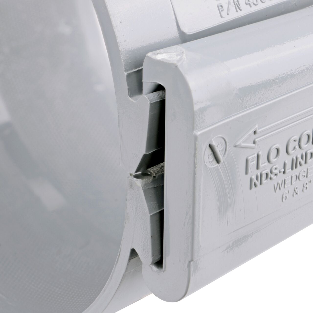 Closeup of the wedge installed securely on the NDS Clamp-It™ Rigid PVC Saddle with 1 in. FPT connection on top (NDS 446010) for 6 in. PVC pipe