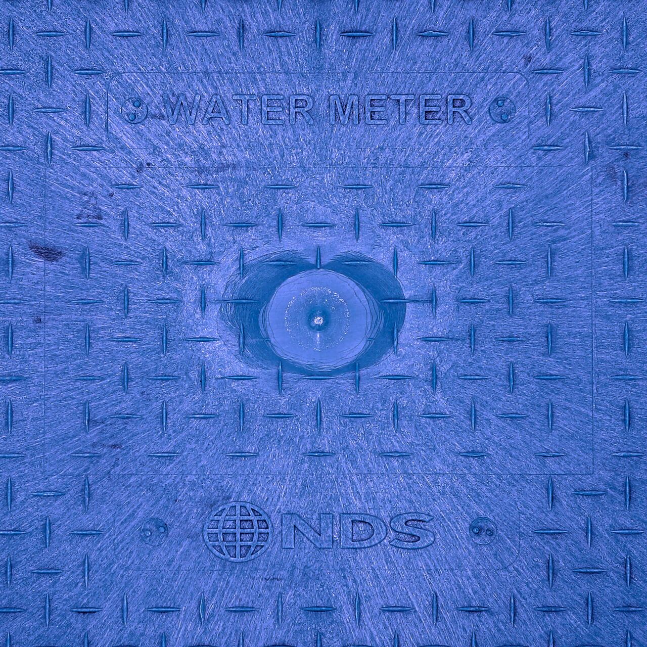 Closeup view of the Water Meter markings on the Blue Water Meter Drop-in cover for the NDS 14 in. X 19 in. Rectangular Standard Series Meter Cover (NDS D1200-DISBLUL)