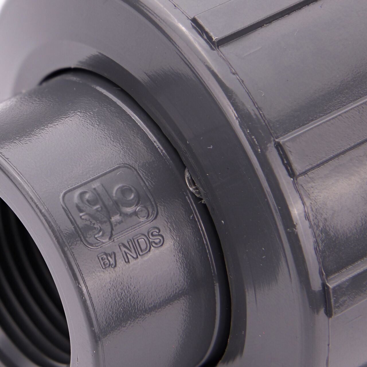 Close up view of the NDS 3/4 in. PVC FPT Union showing NDS brand a leader in flow management solutions and the preferred choice of professionals since 1972 mark (NDS U-0750-T)