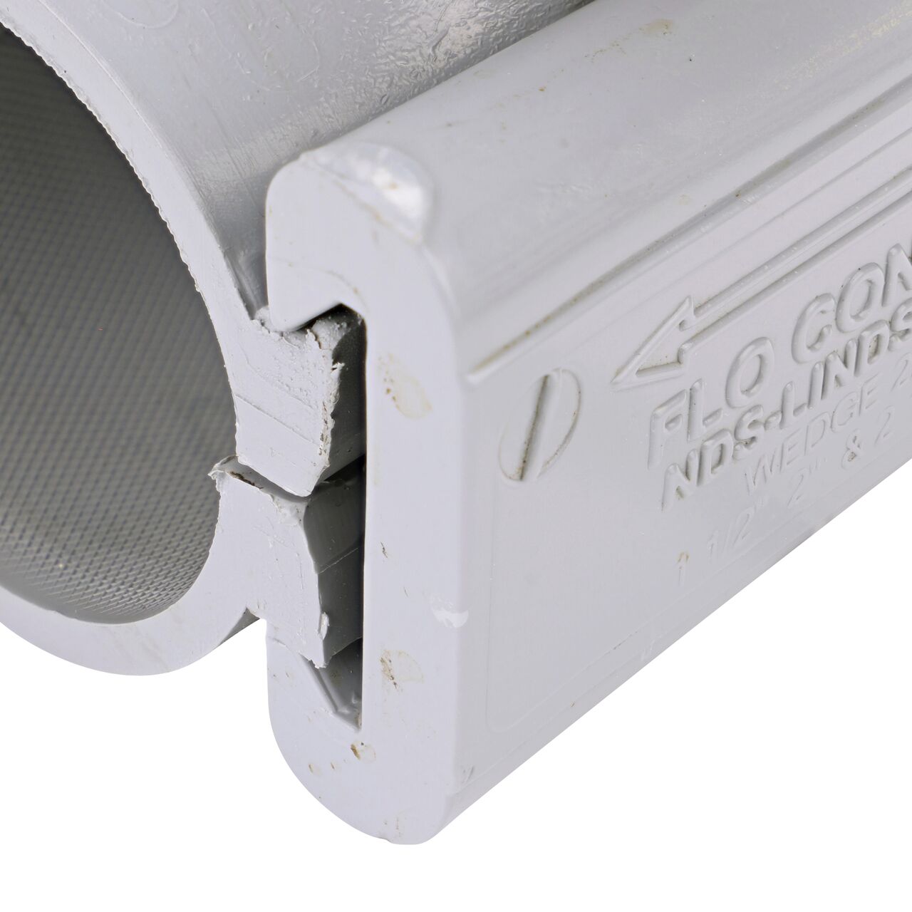 Closeup view of the wedge securely in the closed position on the 2 in. NDS Flo-Tap™ Rigid PVC saddle with 1-1/2 in. socket or 2 in. spigot (NDS 3220)