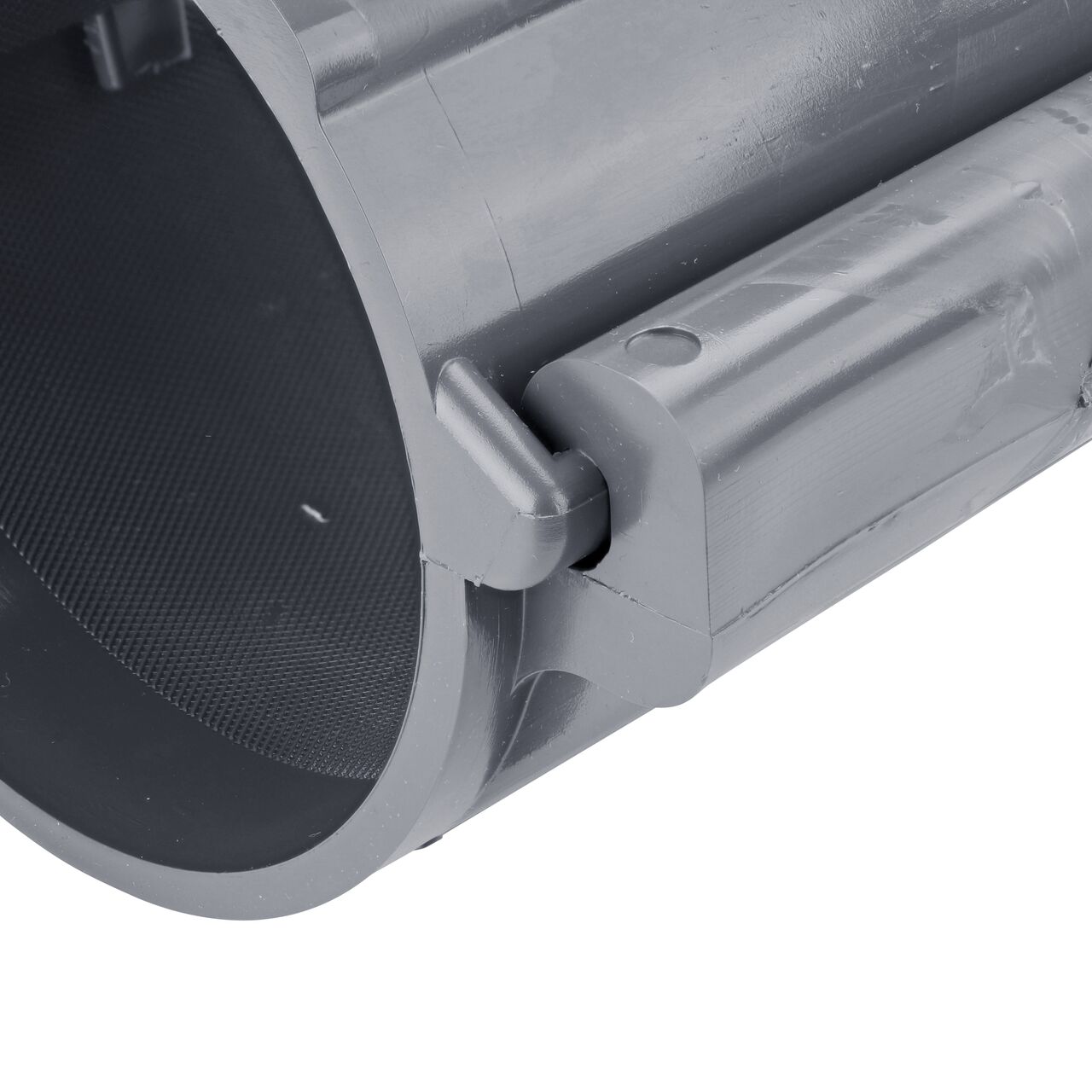 Closeup of the hinge closed on the NDS Clamp-It™ Rigid PVC Saddle with 1-1/4 in. FPT connection on top (NDS 444012) for 4 in. PVC pipe