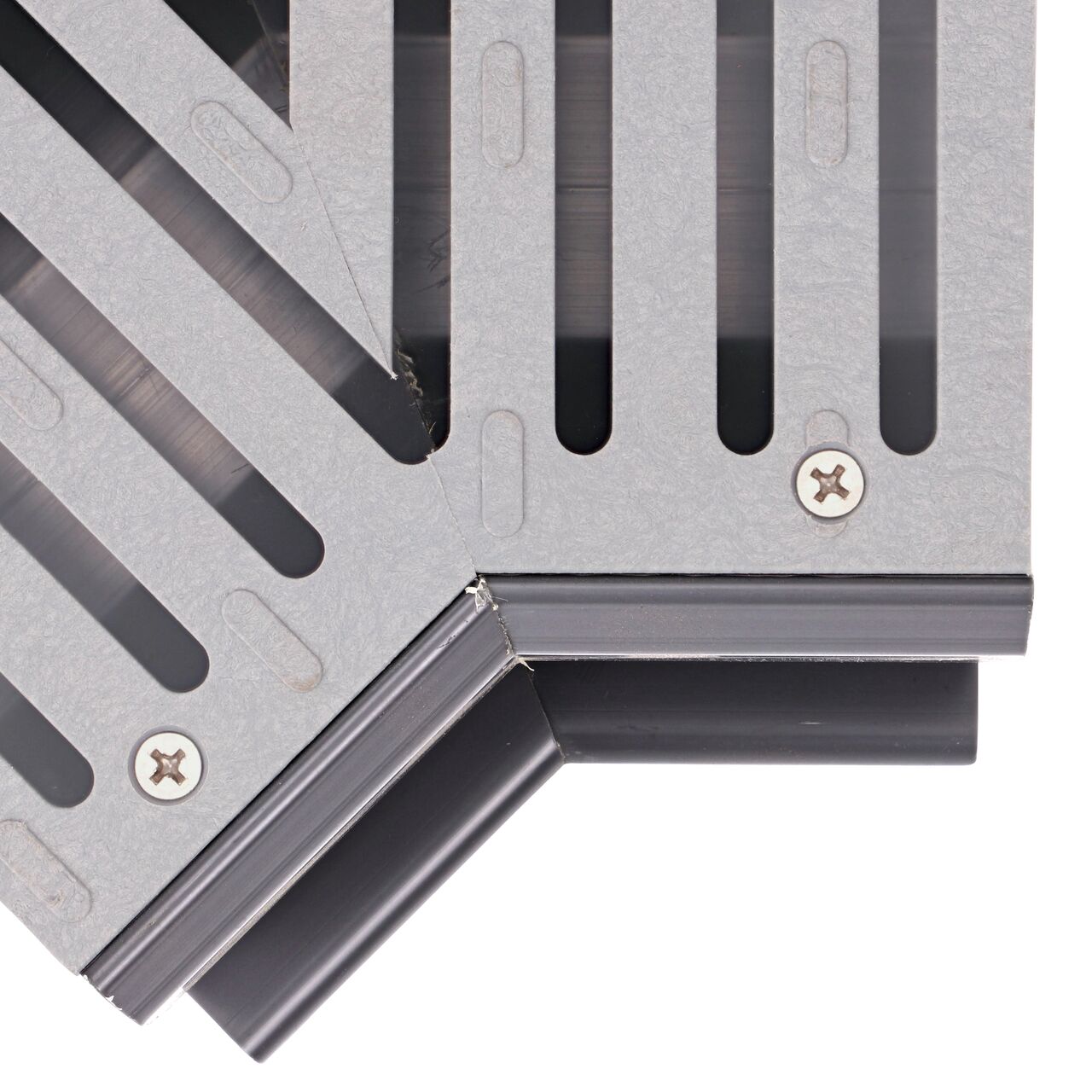 Closeup view of how the grate sits in the drain and the shape of the gray NDS Spee-D® Channel Drain and Grate with 45° Elbow (NDS 2301)