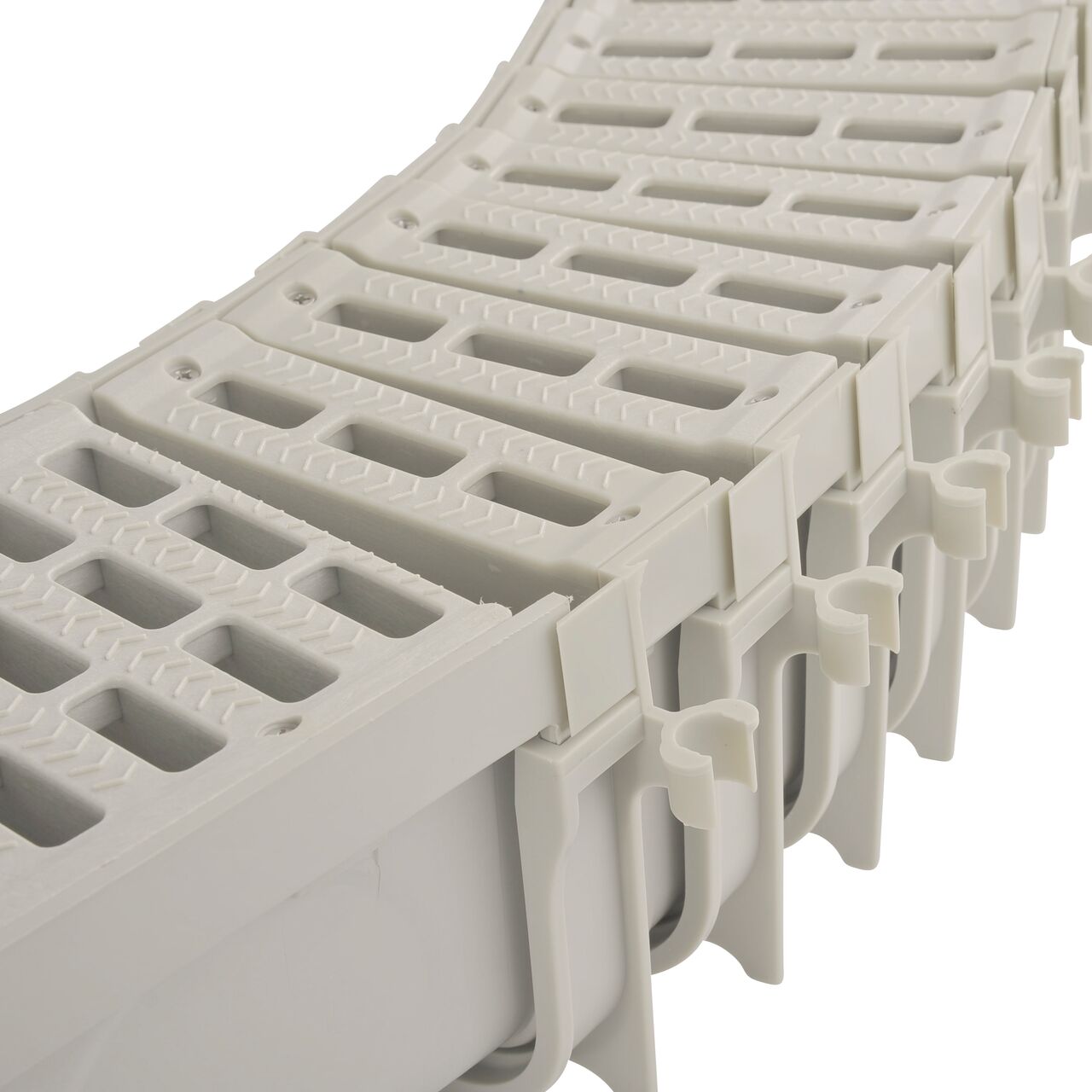 Close-up view of a series of 5 in. Pro Series Channel™ Drain Qwik-Turn™ Deep Profile Radius Couplings connected to a 5 in. Pro Series Deep Profile Channel Drain (NDS 800, NDS PSRC-864)