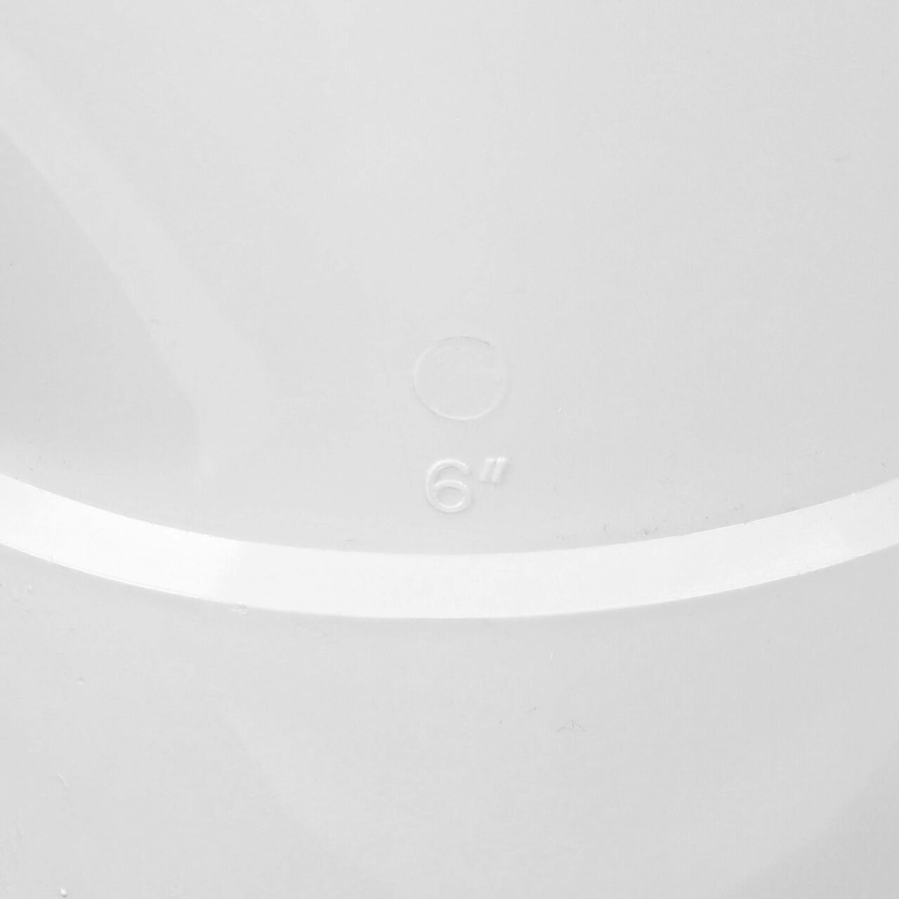 Closeup of the wording of the PVC sanitary tee for 6 in. Sewer and Drain pipes, Hub X Hub X Hub connection (NDS 6P09)