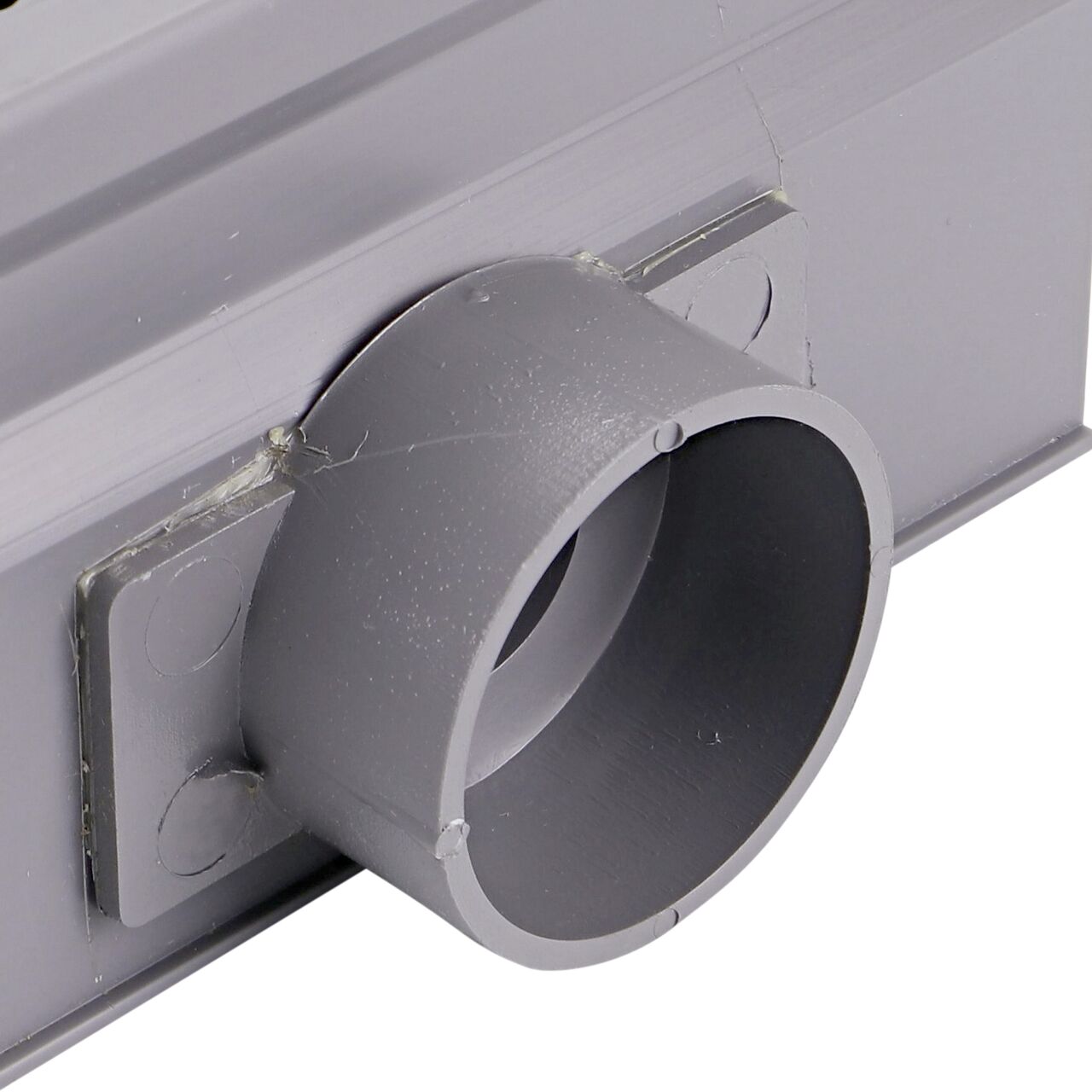 Closeup of the outlet opening of the NDS Gray Micro Channel™ Drain & Integrated Grate Side Outlet (NDS 8513)