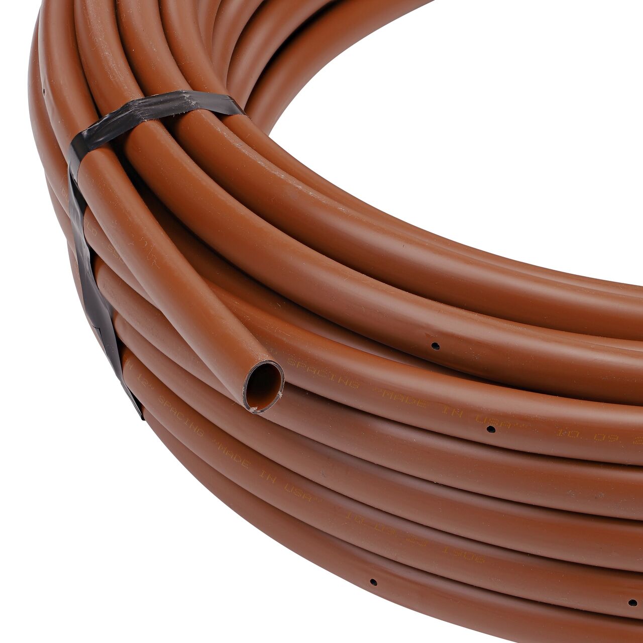 Closeup view of the outside end of the 100 foot brown NDS 16mm Dura Flo™ Dripline with 1.0 GPH Pressure Compensating Emitters spaced 12 in. apart