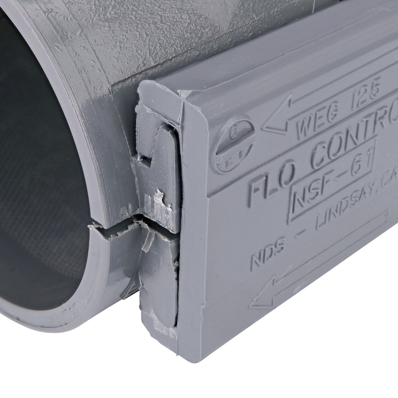 Closeup of the wedge installed securely on the NDS Clamp-It™ Rigid PVC Saddle for 2 in. PE pipe with 1 in. slip on top (NDS 332010P)