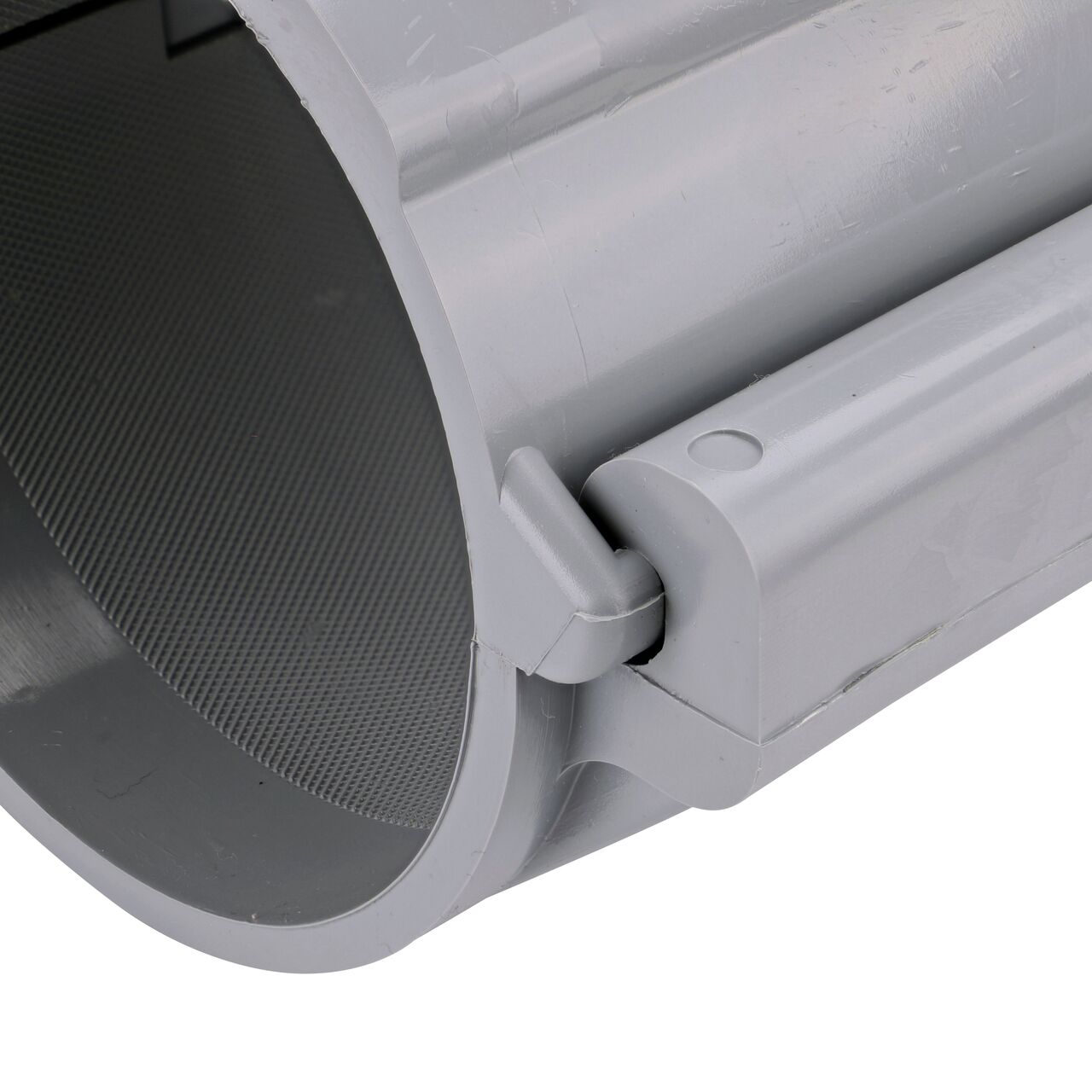 Closeup of the hinge closed on the NDS Clamp-It™ Rigid PVC Saddle with 2 in. slip connection on top (NDS 454020) for 4 in. PVC pipe