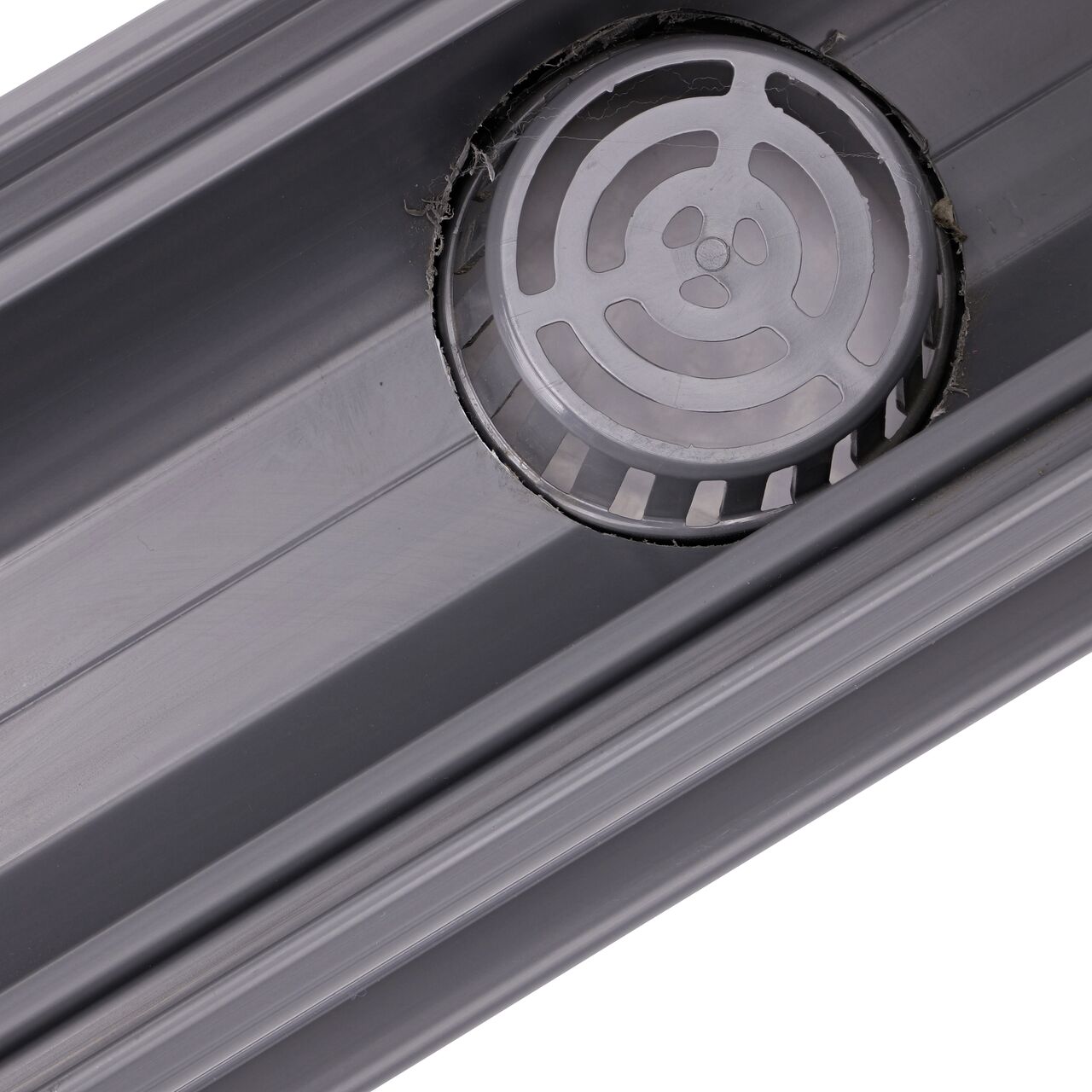 Inside view of the bottom outlet grate connected to the NDS Spee-D® Channel Drain with Bottom Outlet (NDS 234) which collects and conveys stormwater away for proper release downstream