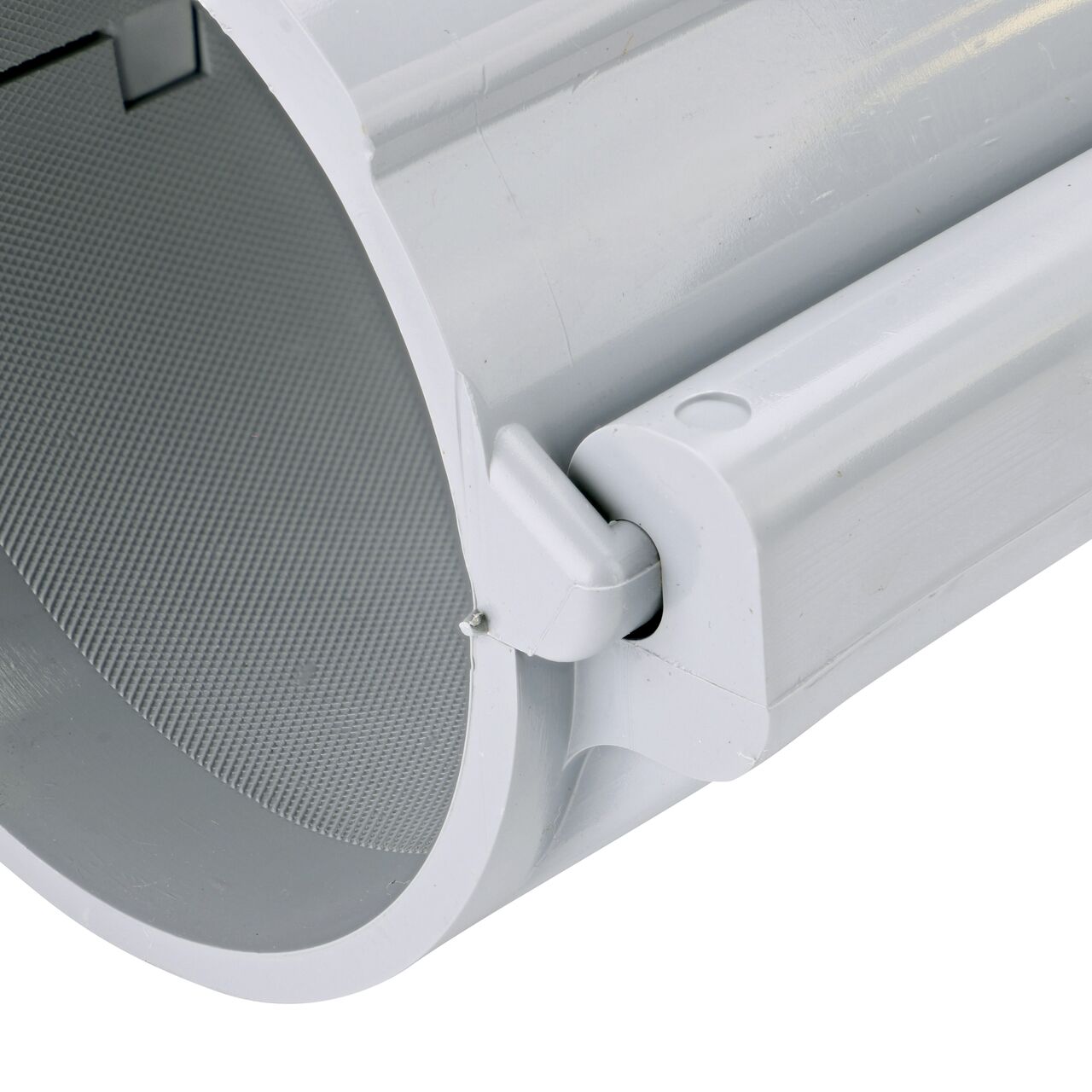 Closeup of the hinge closed on the NDS Clamp-It™ Rigid PVC Saddle with 1-1/2 in. FPT connection on top (NDS 444015) for 4 in. PVC pipe