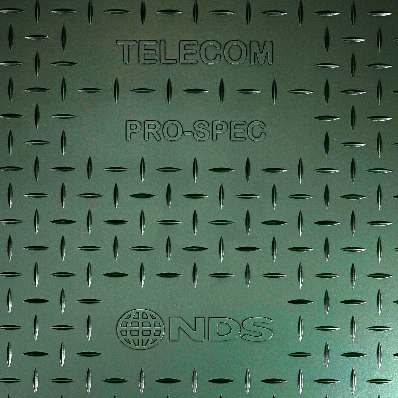 Closeup view of the Telecom markings on the Green telecom cover for the NDS 14 in. X 19 in. X 24 in. Rectangular Pro-Spec Series Telecom Box & Cover (NDS 327BCBT)