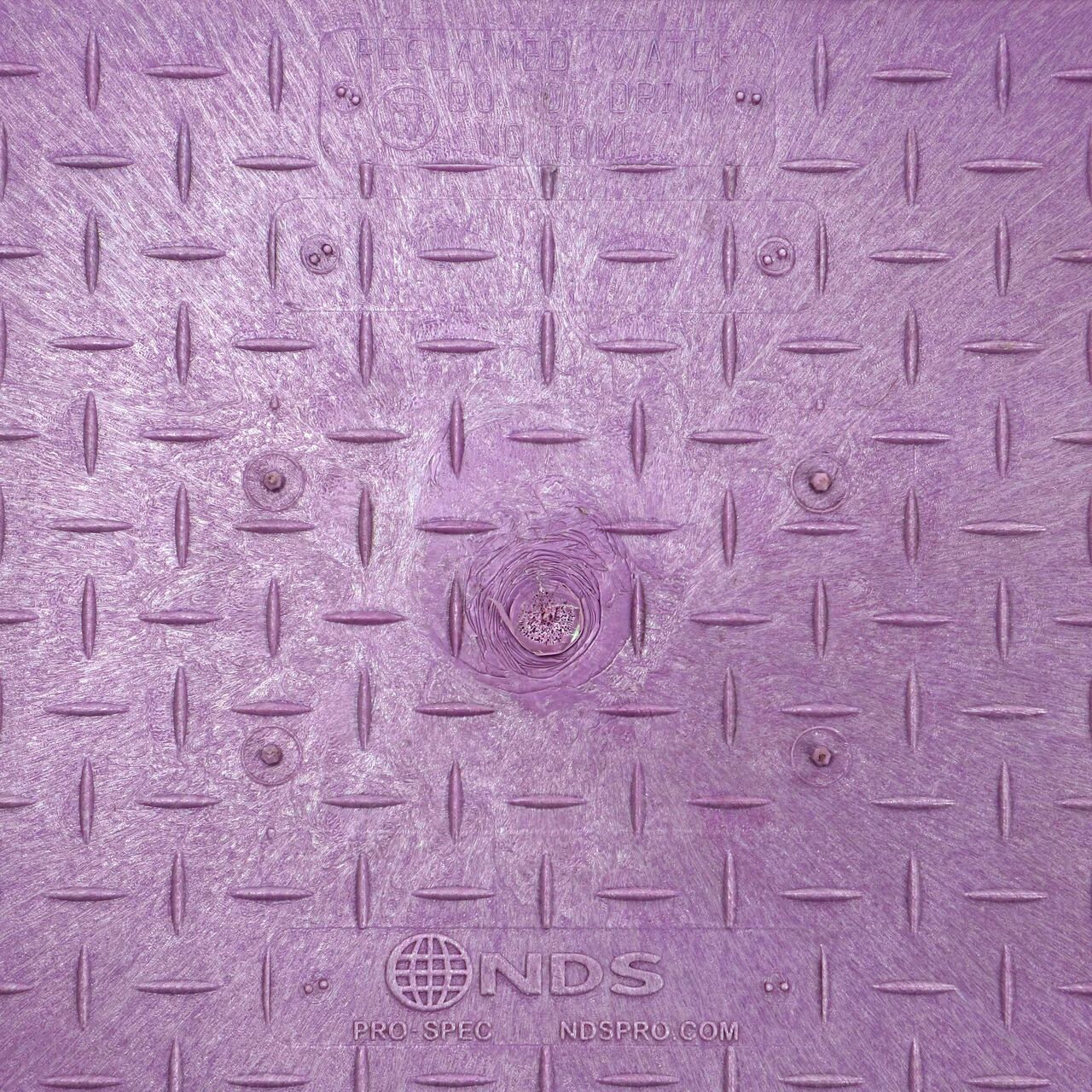 Closeup view of the Reclaimed Water markings on the Purple Reclaimed Water cover for the NDS 13 in. X 24 in. Rectangular Pro-Spec® Series Valve Box (NDS 322PBCBR)