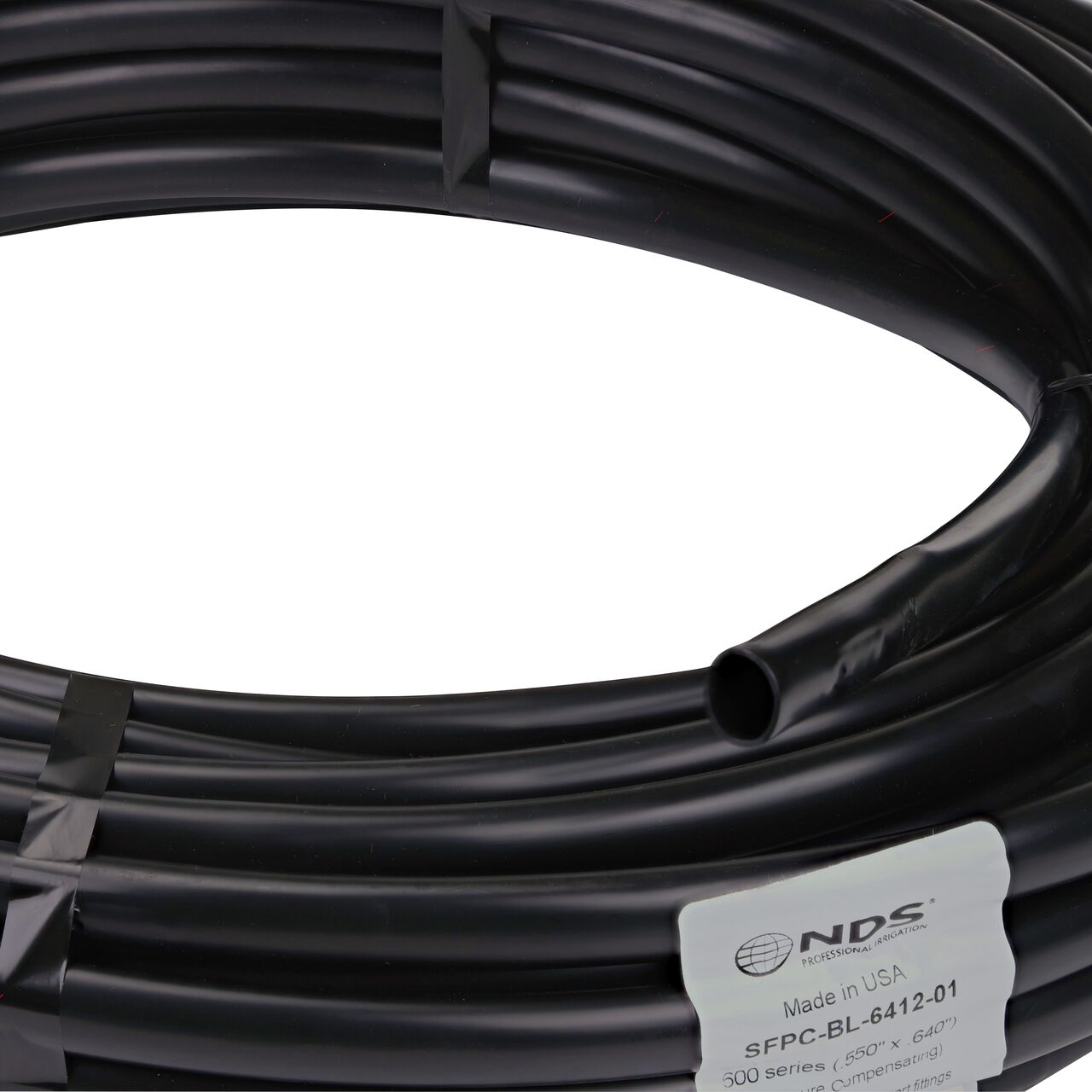 Closeup of the diameter of the NDS Black Tubing with 1.0 GPH Pressure Compensating Emitters iwth 12 in. Spacing (NDS SFPC-6412-01)