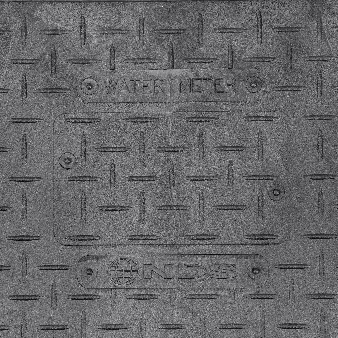 Closeup view of the Water Meter markings on the Black Water Meter Overlapping cover for the NDS 14 in. X 19 in. Rectangular Standard Series Meter Cover (NDS D1200-OLSBL)