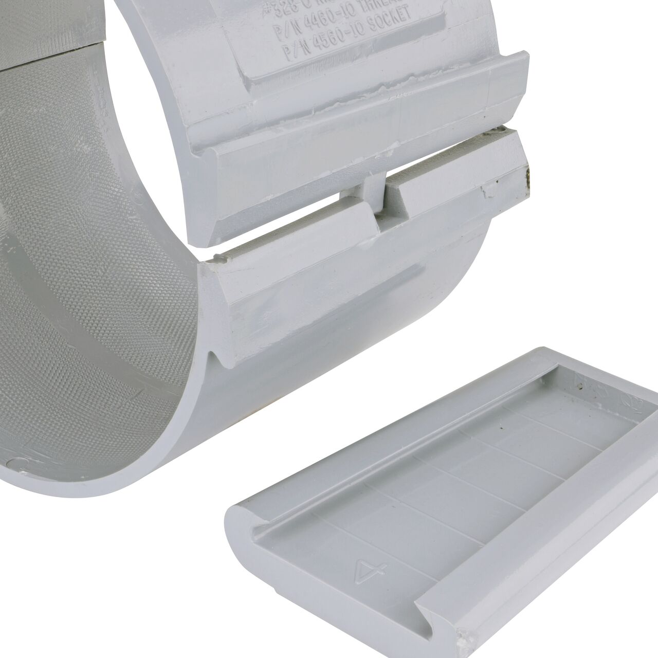 Closeup of the wedge latch uninstalled on the NDS Clamp-It™ Rigid PVC Saddle with 1 in. FPT connection on top (NDS 446010) for 6 in. PVC pipe