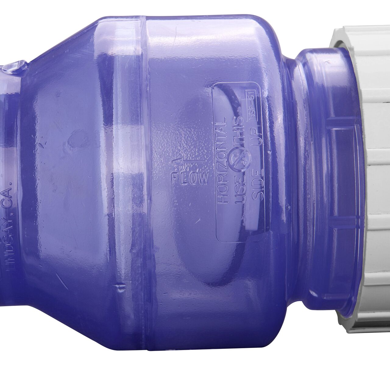 Closeup of the directional arrows showing which water the water flows through the NDS Clear 3 in. IPS U X U PVC True Union Swing Check Valve (NDS 1720C30)