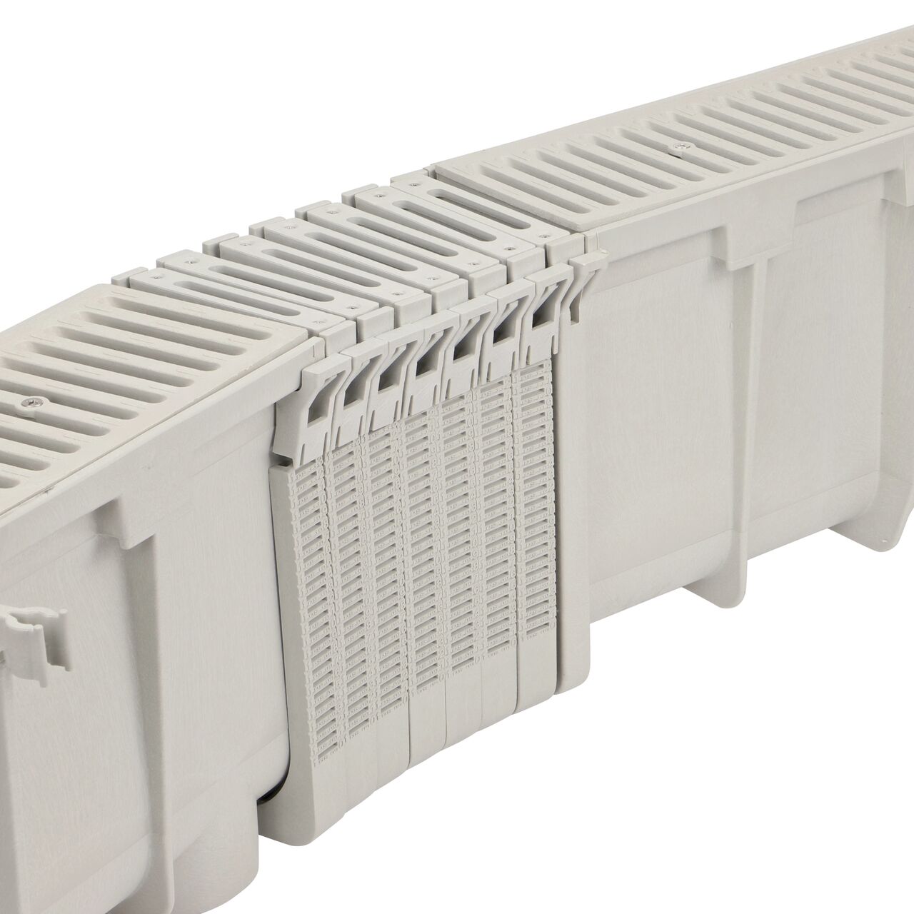 Side view of the bend of multiple NDS Dura Slope® Channel Drain EZ-Track™ Radius Couplings (NDS DSRC) and grates when attached to the Dura Slope Channel Drain system