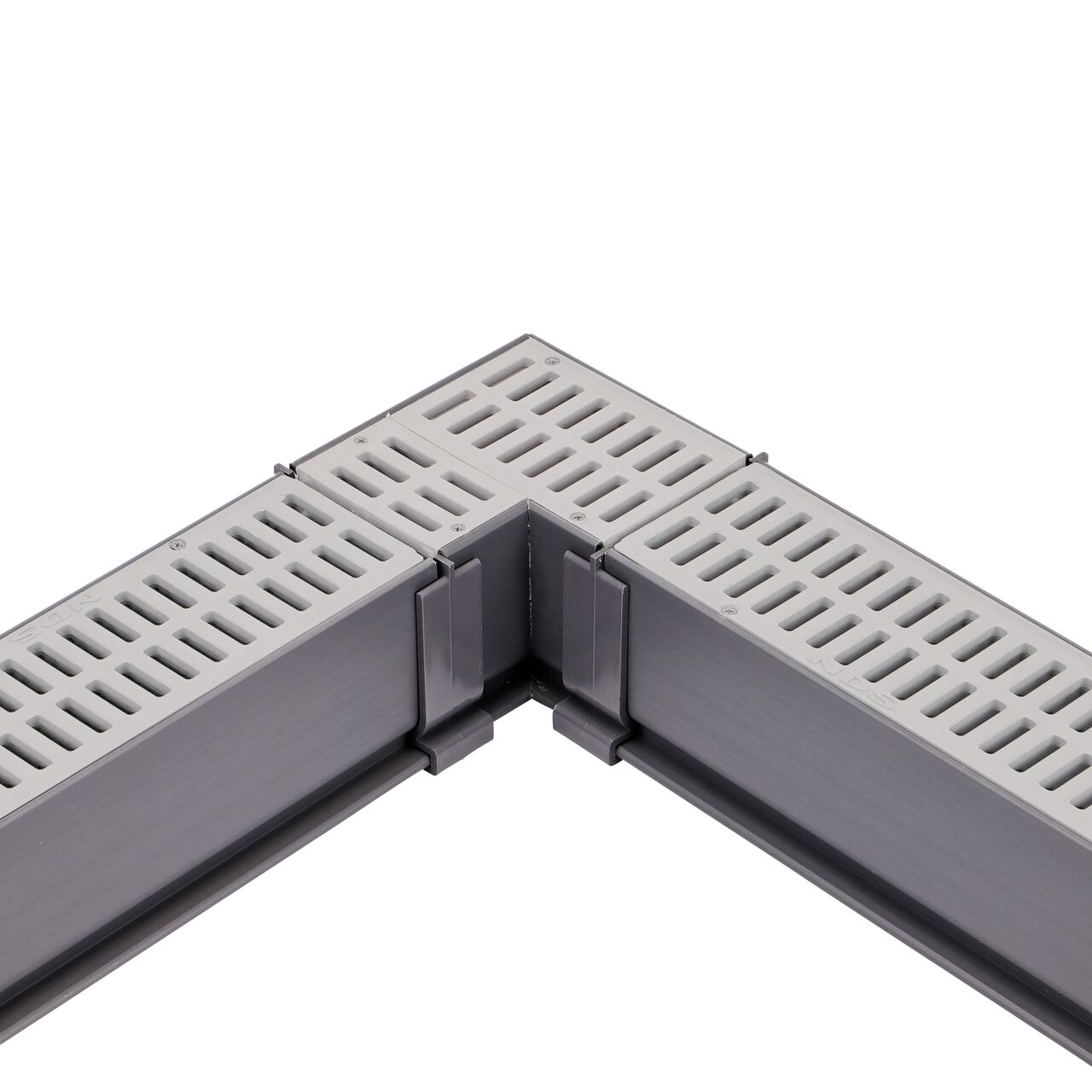 Fully installed NDS Gray Mini Channel™ Drain 90° Elbow and Grate (NDS 5380) with couplers and channel drains with grates