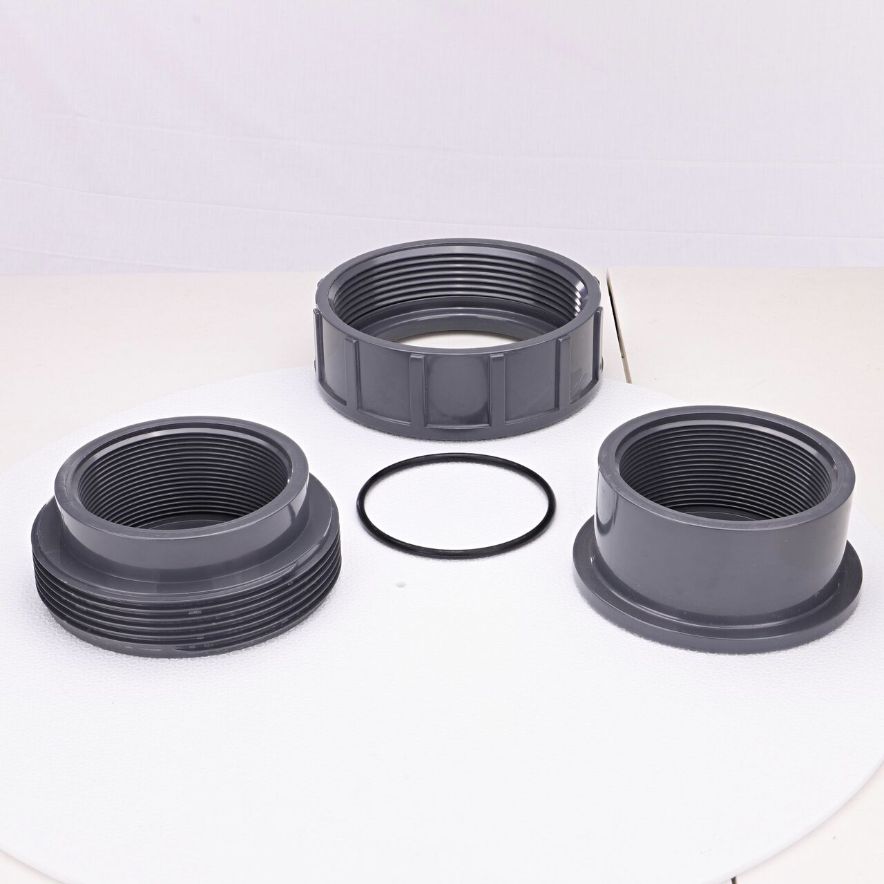 The NDS 4 in. FPT PVC Union shown here unassembled, includes the EPDM O-ring that is placed in the center of the union to create a leak-resistant seal (NDS U-4000-T)