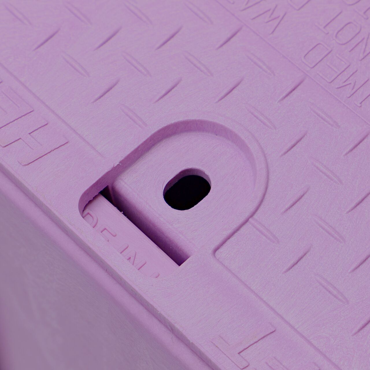 Closeup view of the traditional bolt hole on the Purple NDS 14 in. X 19 in. Rectangular Pro-Spec® Series Valve Box (NDS 314PBCBR) for securing valve lid or cover to the valve box