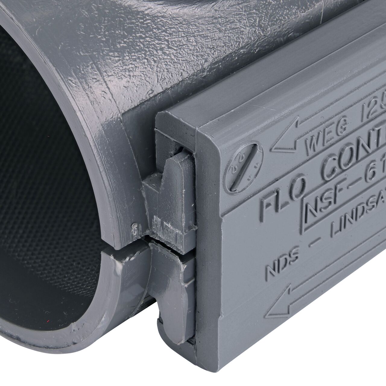 Closeup of the wedge installed securely on the NDS Clamp-It™ Rigid PVC Saddle for 2 in. PE pipe with 1 in. FPT on top (NDS 322010P)