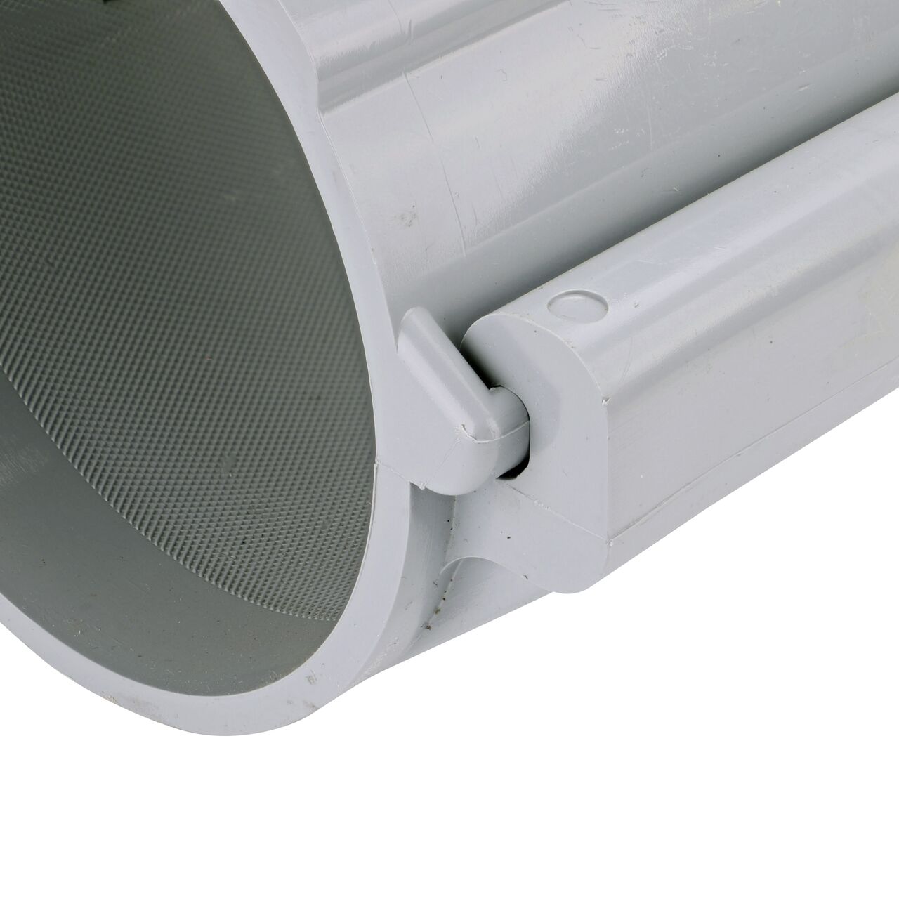 Closeup of the hinge closed on the NDS Clamp-It™ Rigid PVC Saddle with 1 in. slip connection on top (NDS 454010) for 4 in. PVC pipe