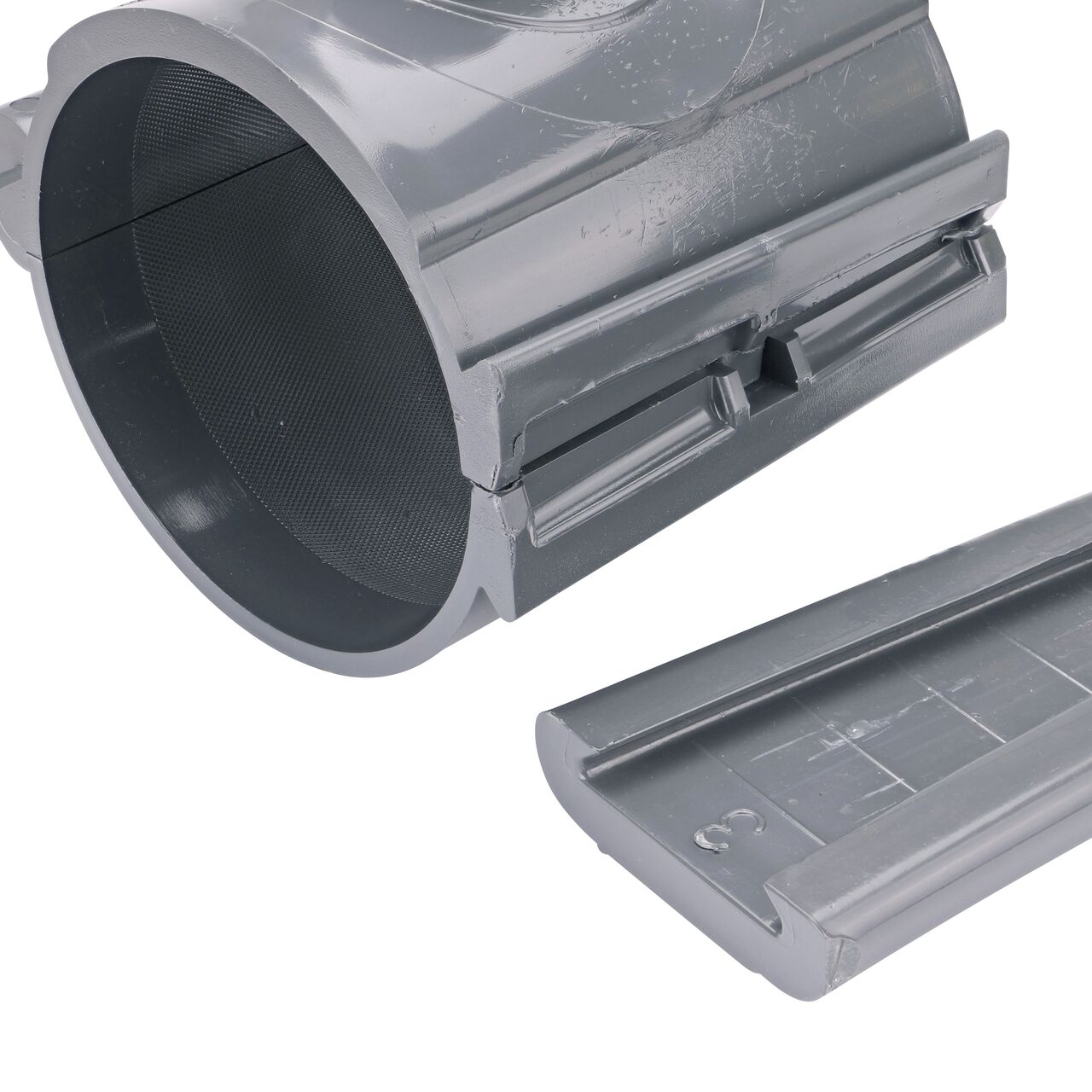 Closeup of the wedge latch uninstalled on the NDS Clamp-It™ Rigid PVC Saddle with 1-1/4 in. FPT connection on top (NDS 444012) for 4 in. PVC pipe